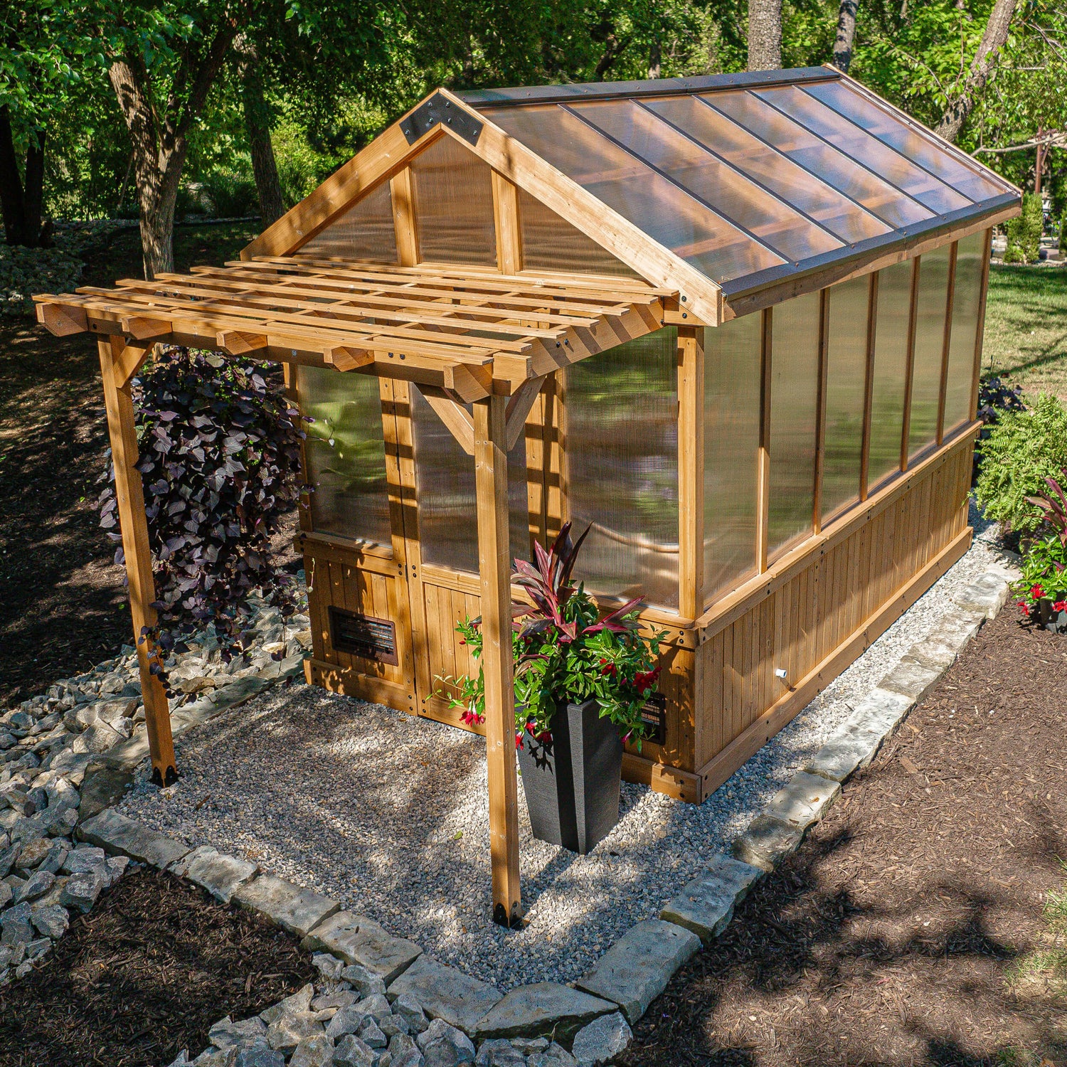 Backyard Discovery Bellerose greenhouse kit with pergola and cedar and polycarbonate construction on a gravel pad.