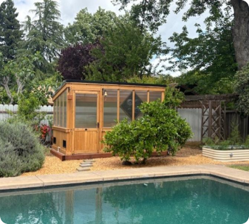 Cedar wooden greenhouse kit with 4-wall polycarbonate in a backyard setting.