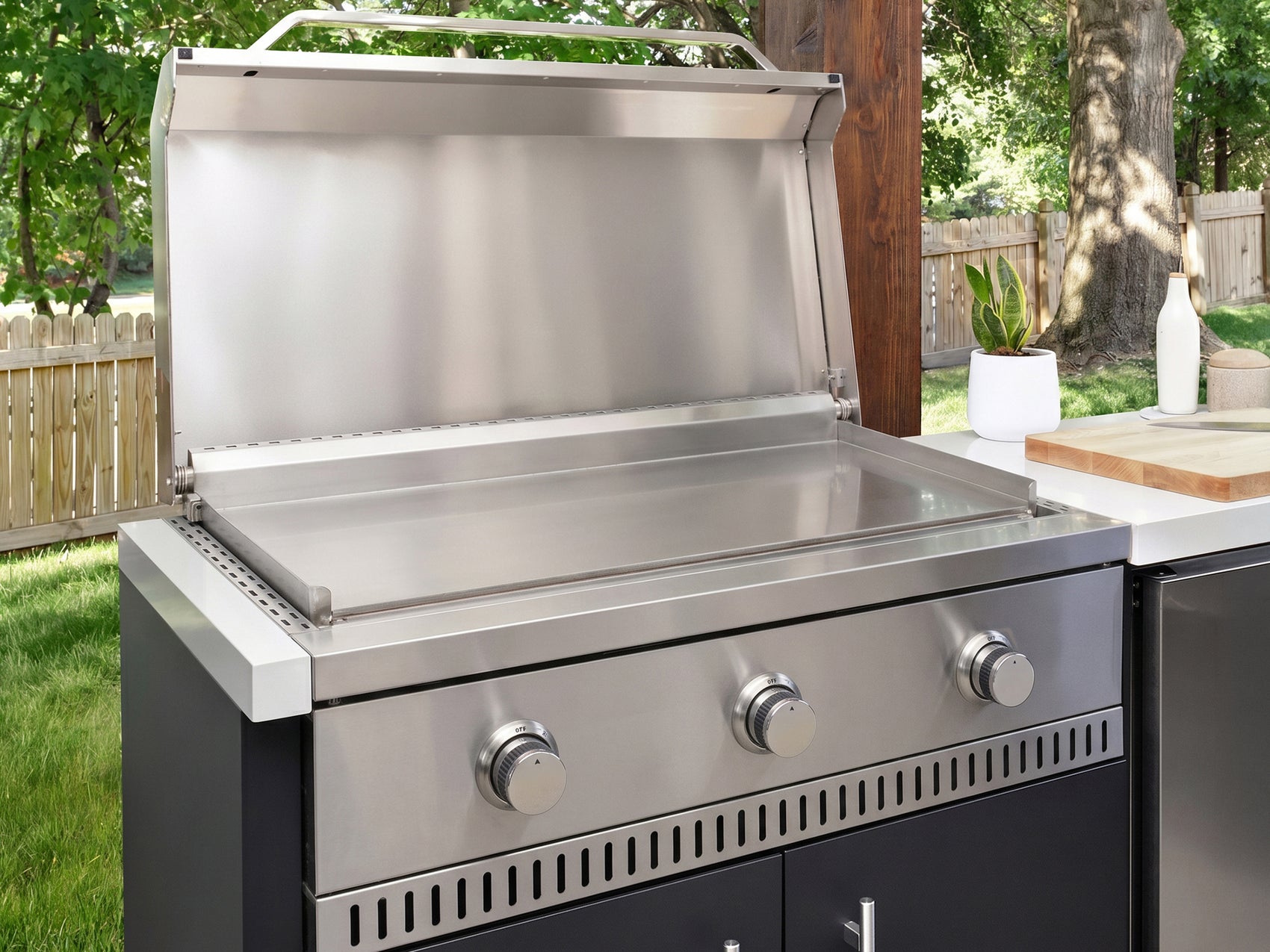 Gas griddle made from stainless steel with a flat top surface and three control knobs in the Emory kitchen.