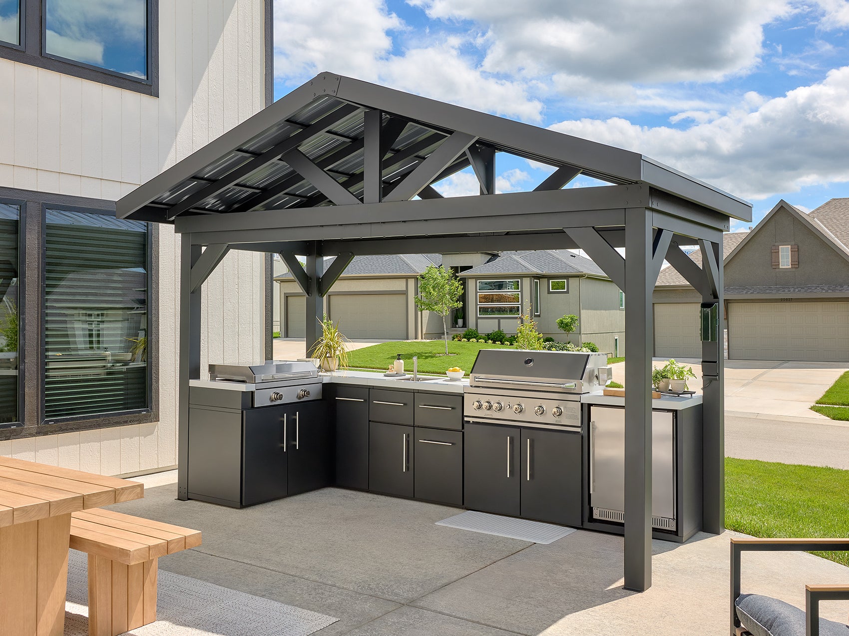 Lancaster L-Shape outdoor kitchen with galvanized steel frame and roof, stainless steel grill, sink.