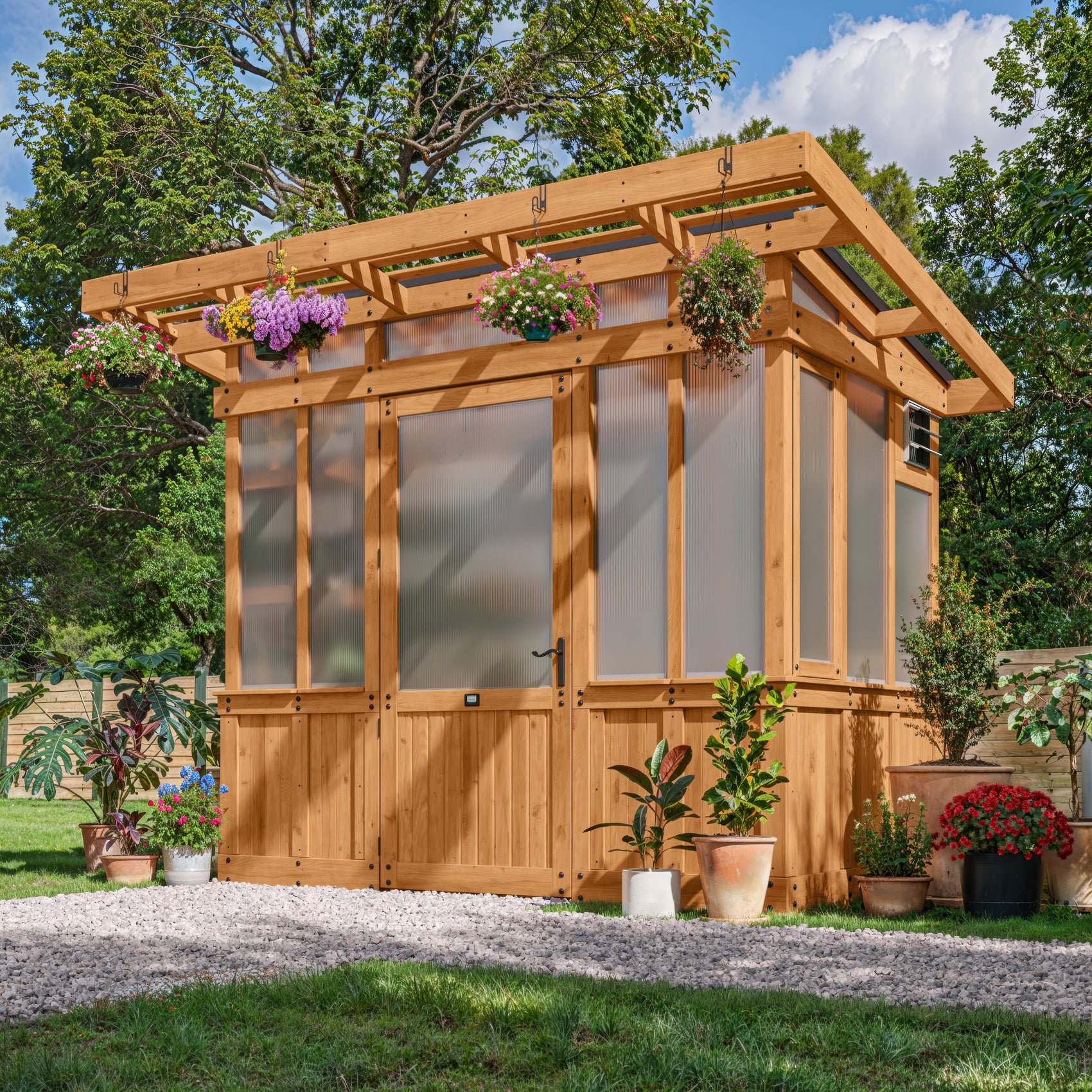 Backyard Discovery Poppy 9x6 greenhouse kit with a pergola overhang, wide entry door, and 4-wall polycarbonate panels.
