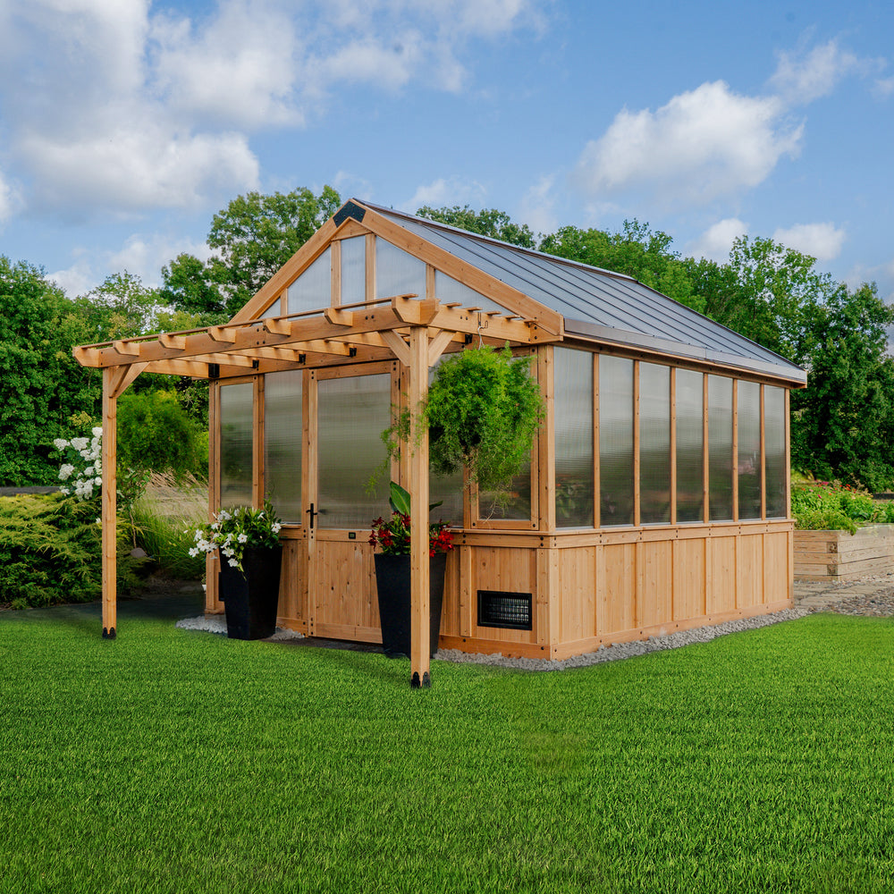 Backyard Discovery Bellerose XL 13x11 greenhouse with a peaked roof, pergola overhang, and wide entry door.