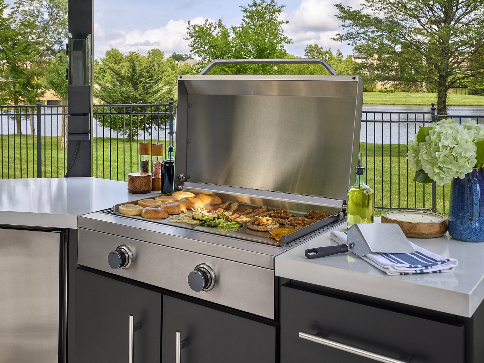 Edgemont Cove Outdoor Kitchen post-mounted weatherproof power port with protective cover closed and tablet mounted on bracket below
