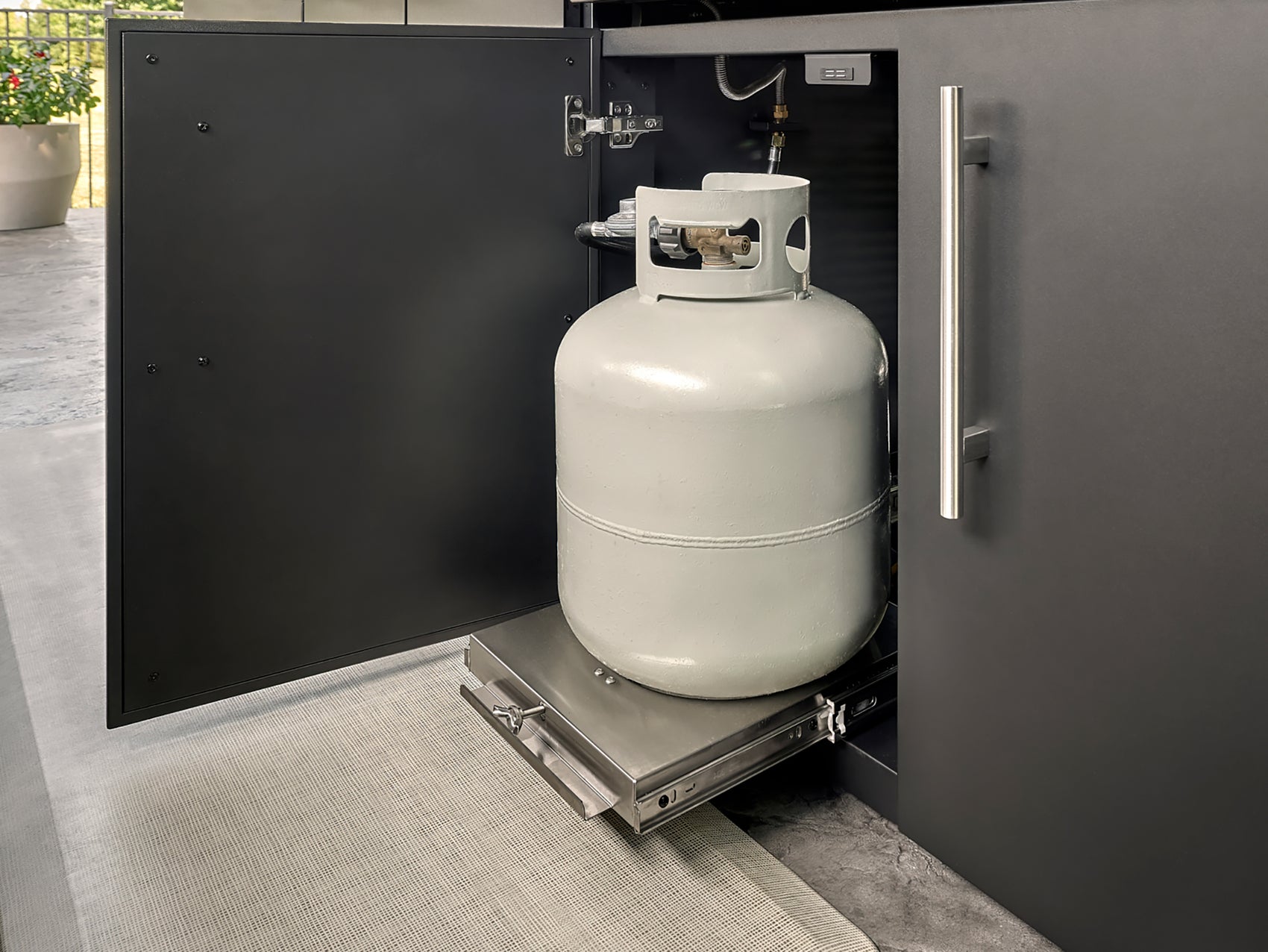 Propane tank slide-out drawer in Lancaster outdoor kitchen cabinet with powder-coated finish.