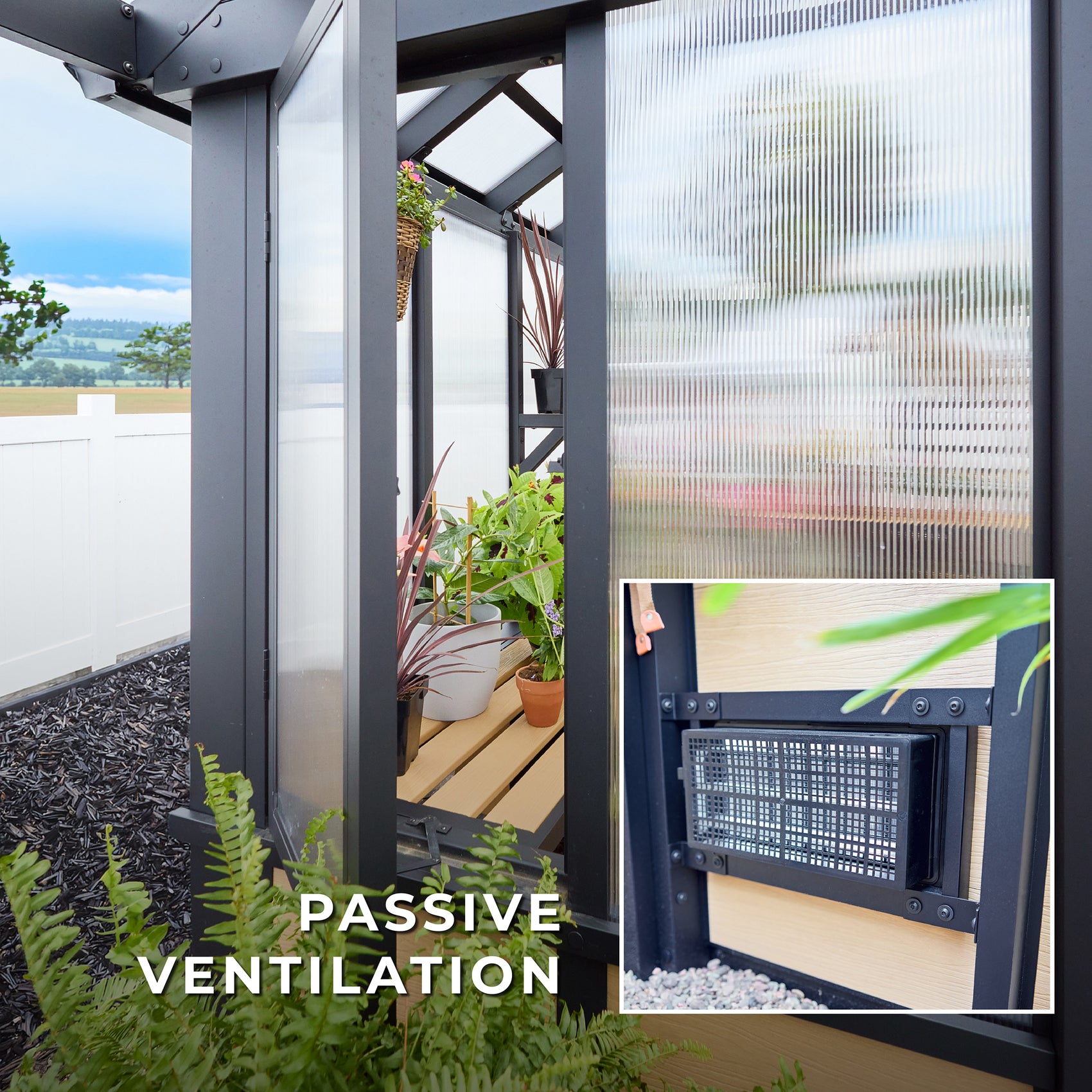 A low intake vent in the Larkspur metal and polycarbonate greenhouse draws fresh air inside for passive ventilation.