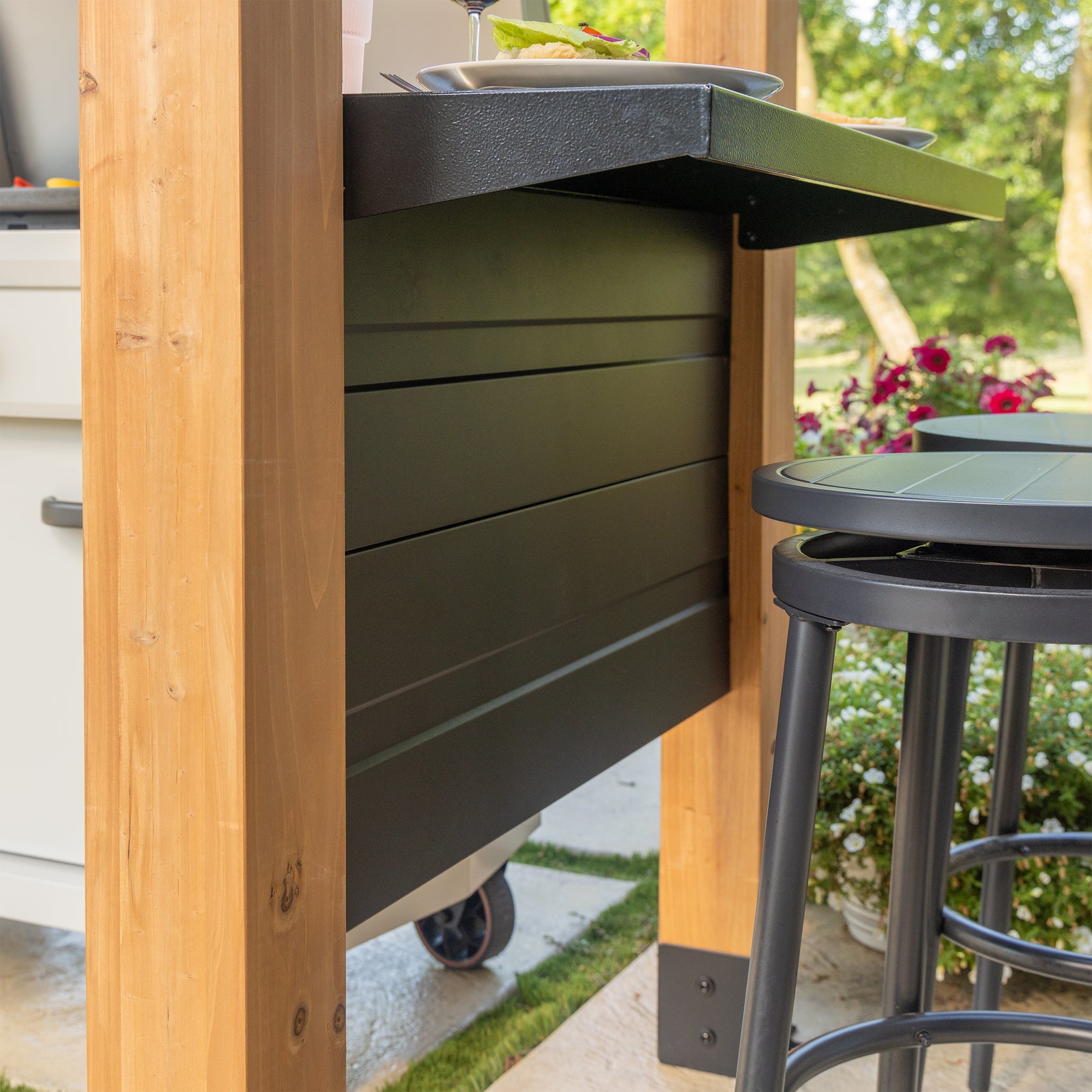 Cedar grilling gazebo with steel panel side wall, bar countertop, and modern stools on outdoor patio.
