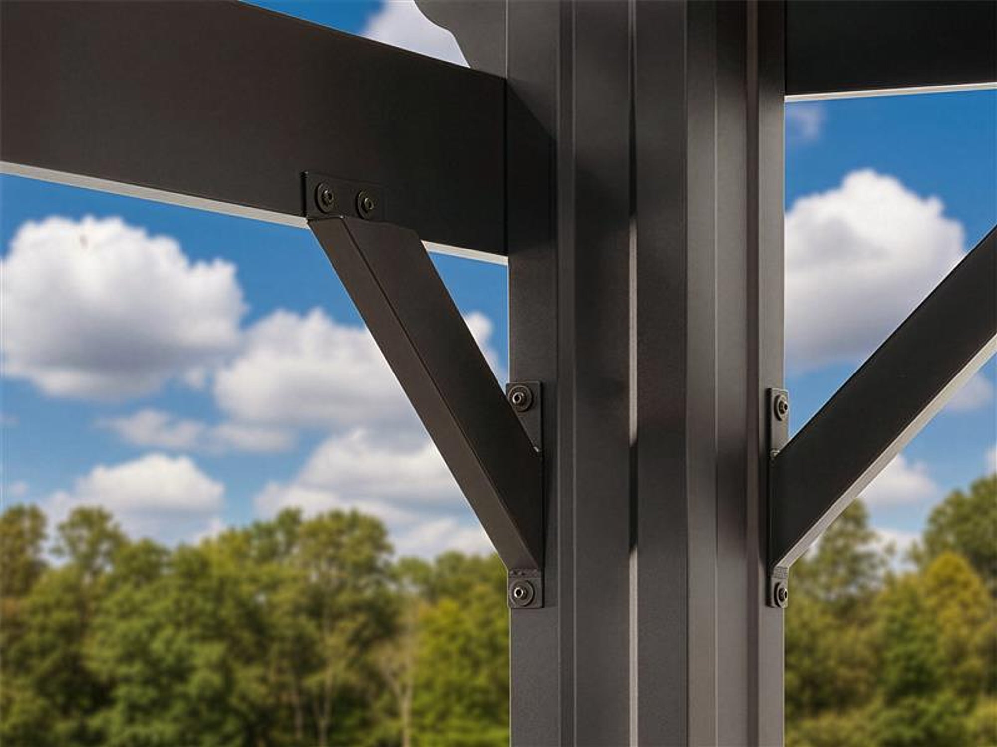 Range Outdoor Living Stratford steel pergola bracket connecting beam to vertical post with bolted fasteners against blue sky.