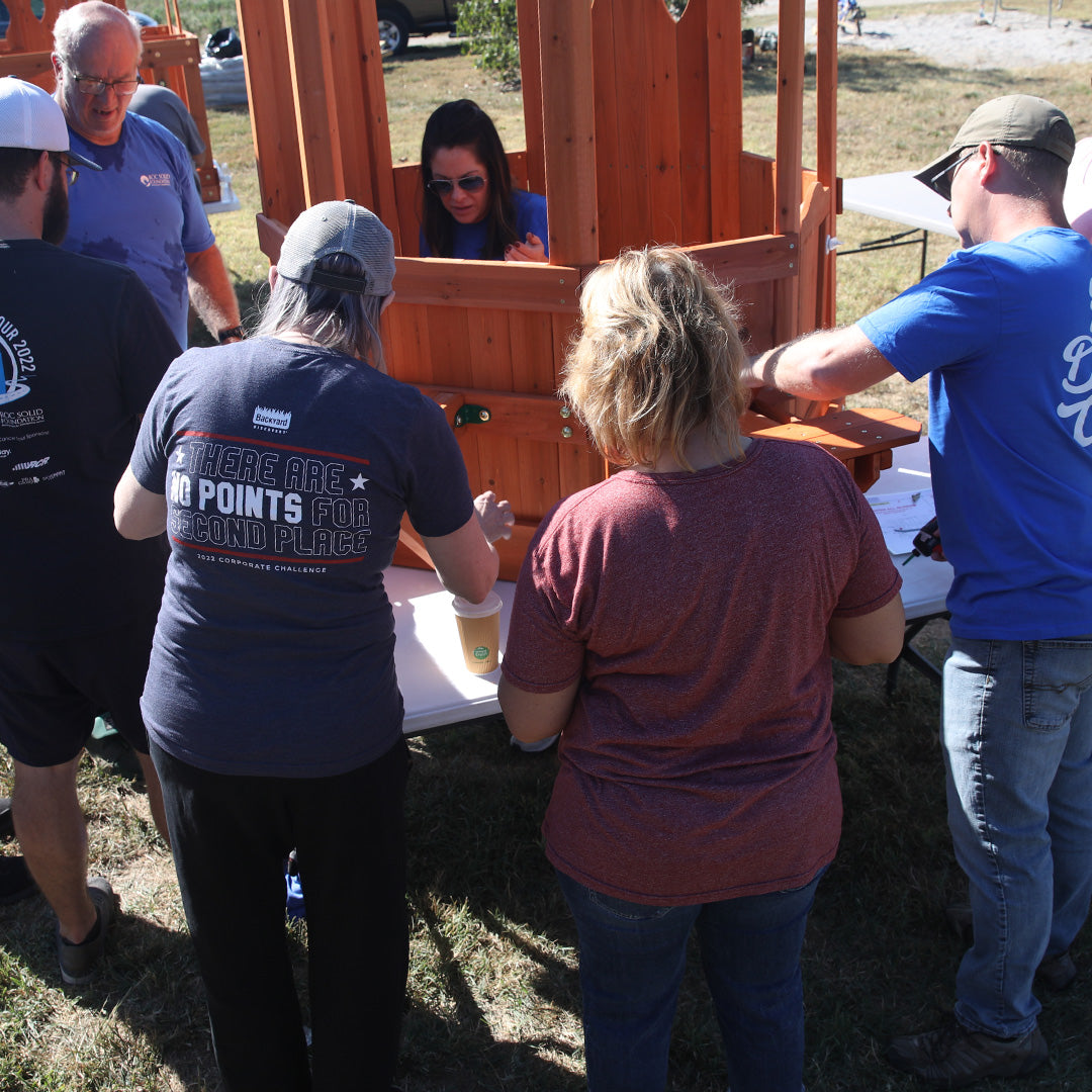 volunteers building a swing set