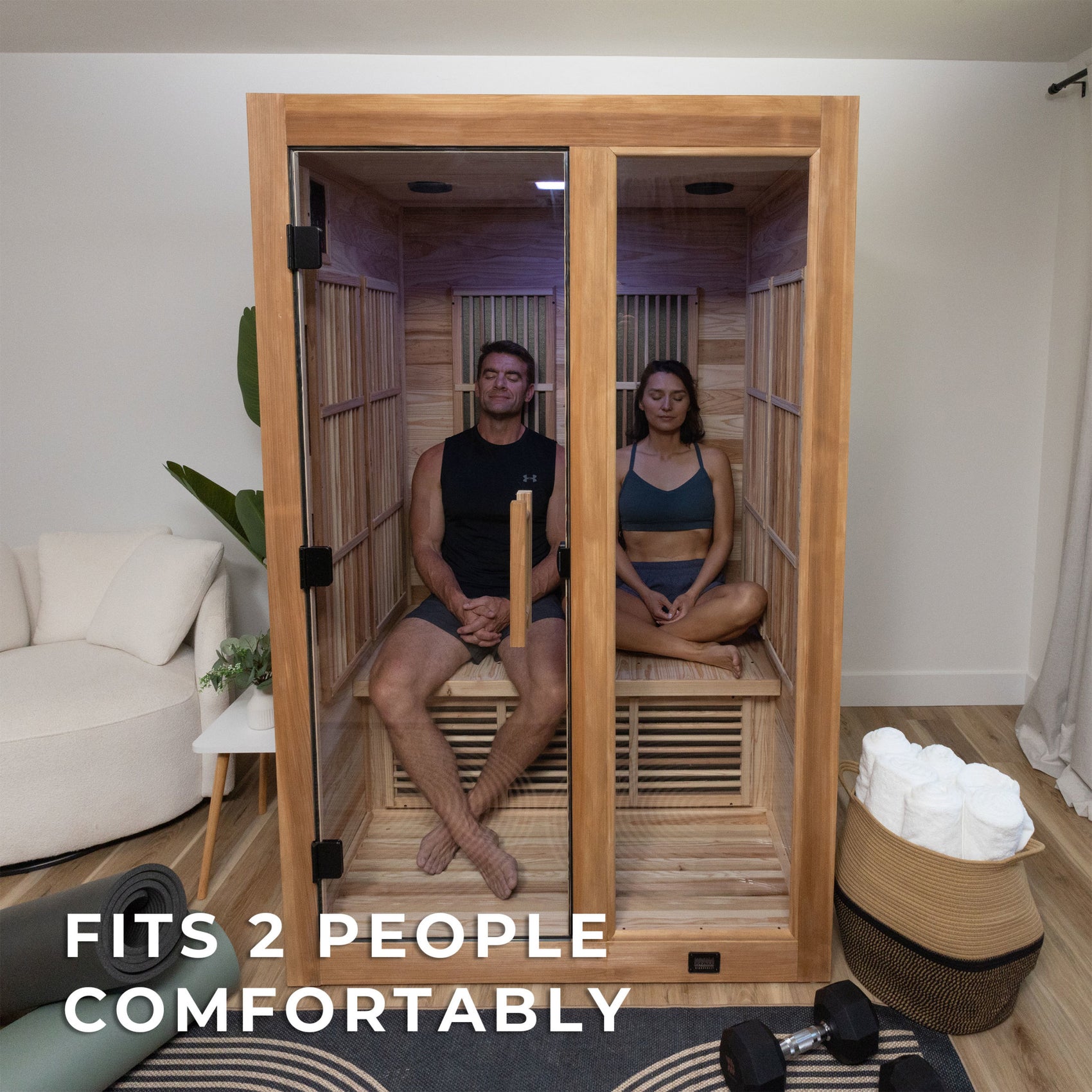 Couple relaxing together on cedar bench inside Rylan infrared home sauna enjoying wellness benefits with chromotherapy