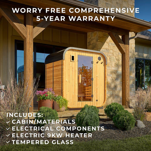Lennon 2-4 person outdoor home sauna installed under covered patio next to stone home with garden beds