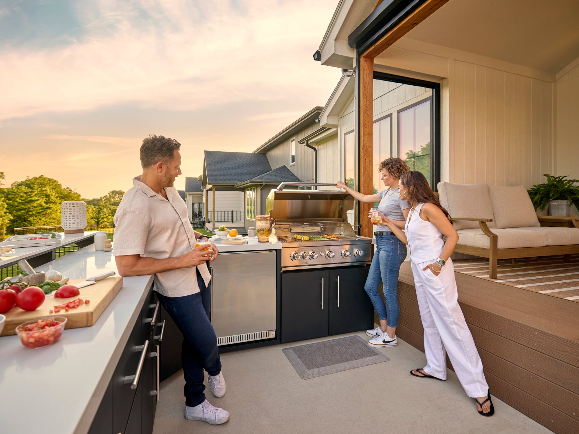 Emory prefab outdoor kitchen with black cabinets, built-in grill, and engineered stone countertop on covered patio.