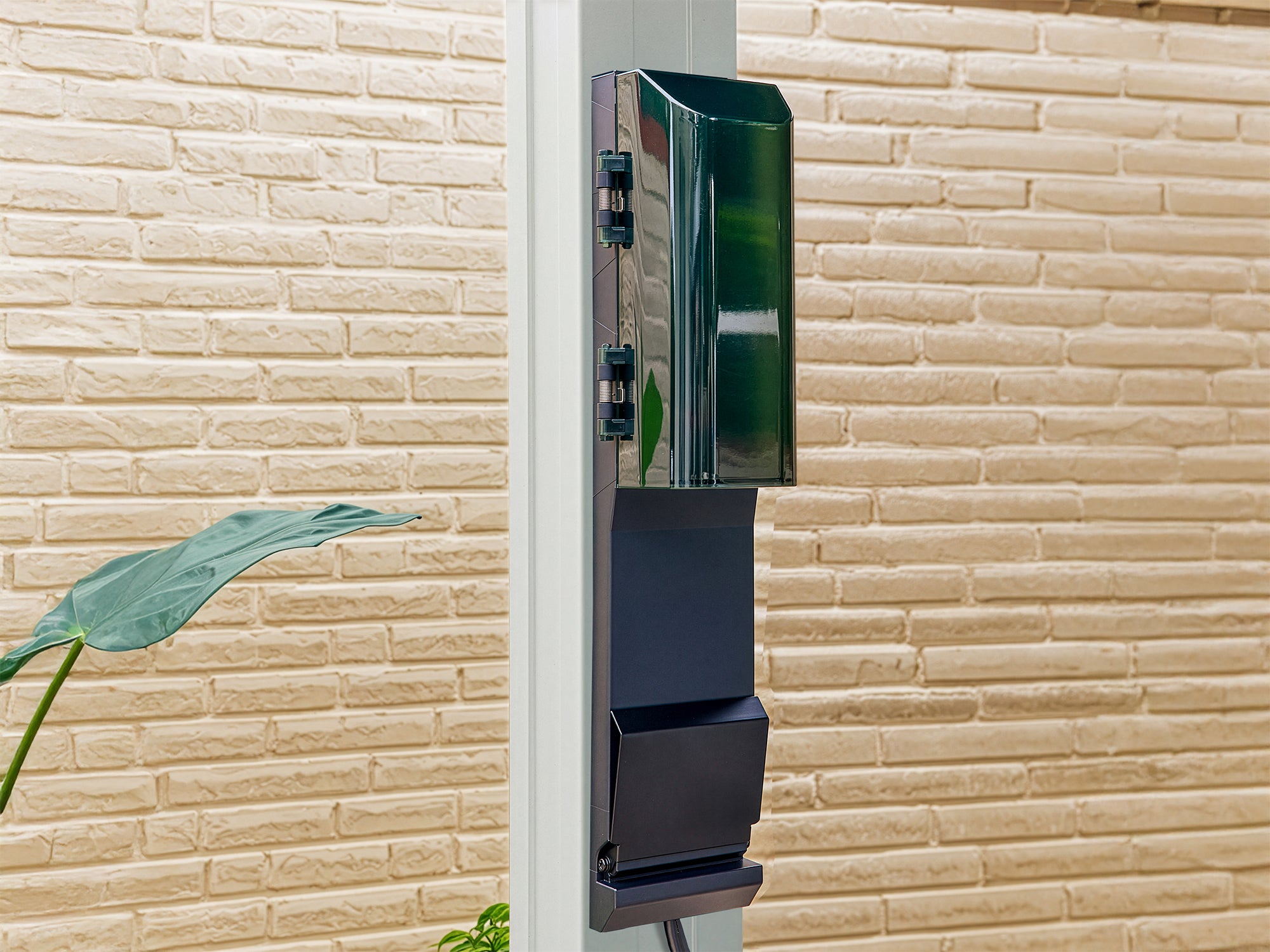 Wall-mounted black power outlet with green translucent cover on Range Outdoor Living Stratford pergola.