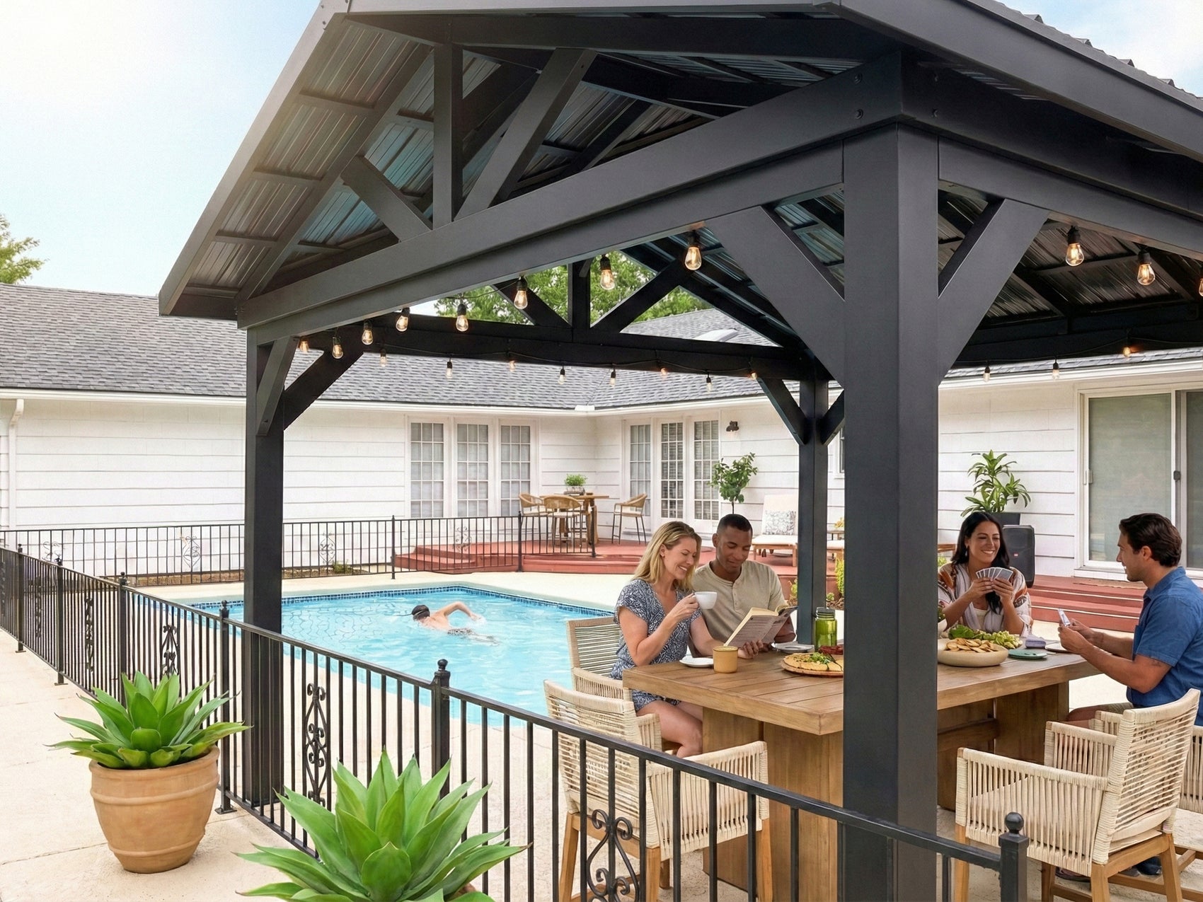 Black metal Lancaster roof gazebo with string lights over backyard pool area with dining tables and family gathering.