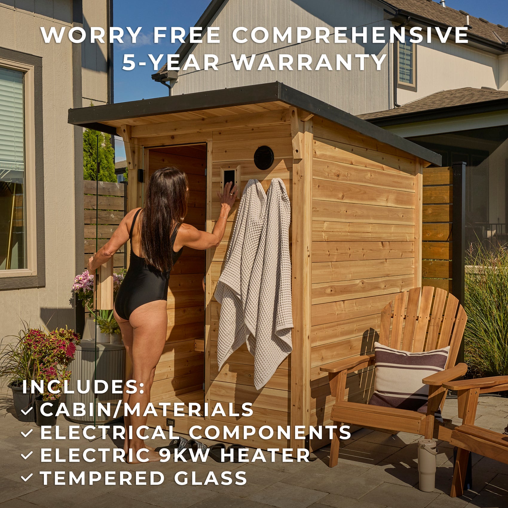 Woman stepping into small outdoor backyard sauna on patio with Adirondack chair and towel hooks