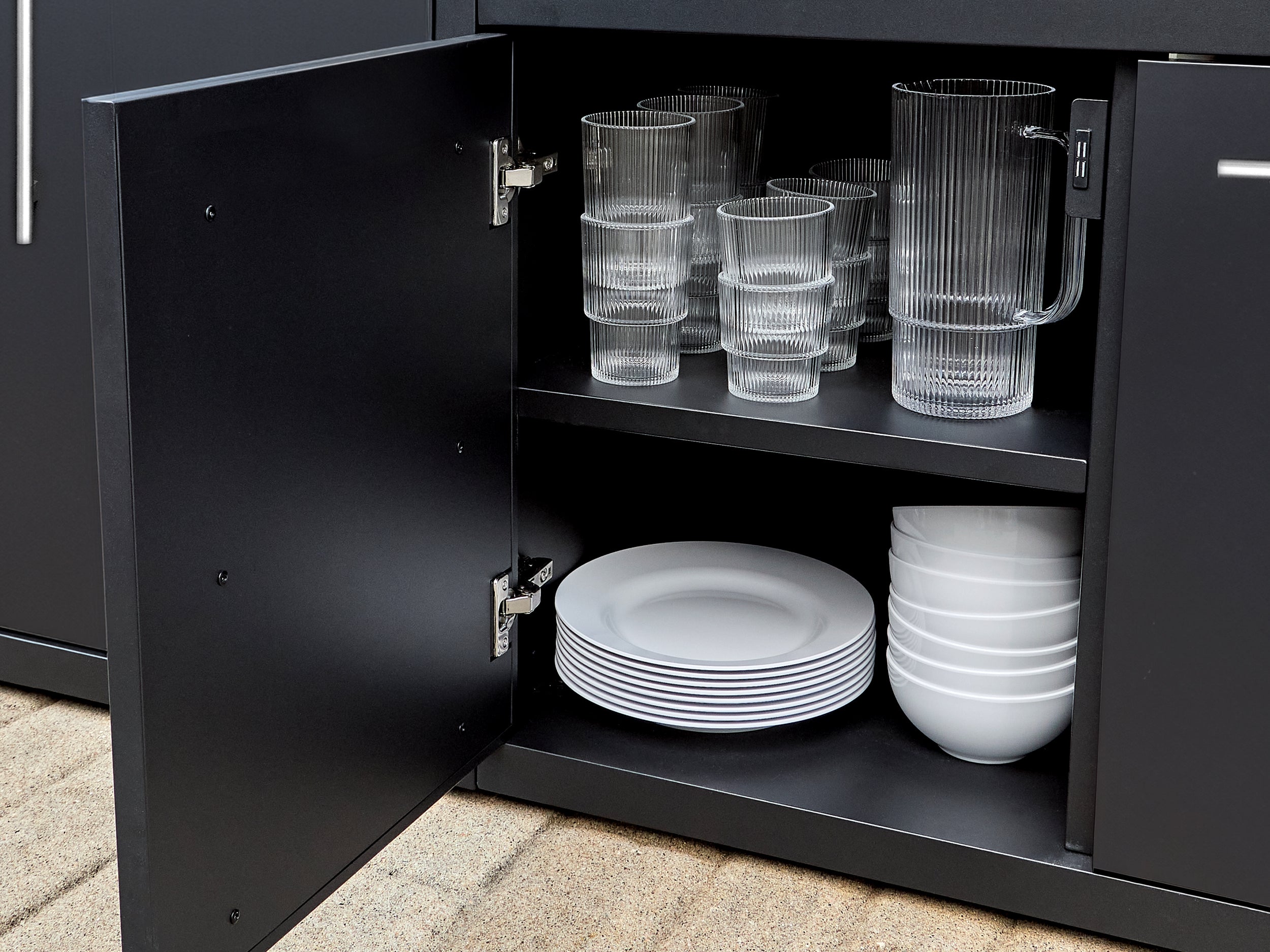 Soft-close cabinet storage with adjustable shelving in powder-coated galvanized steel outdoor kitchen island.