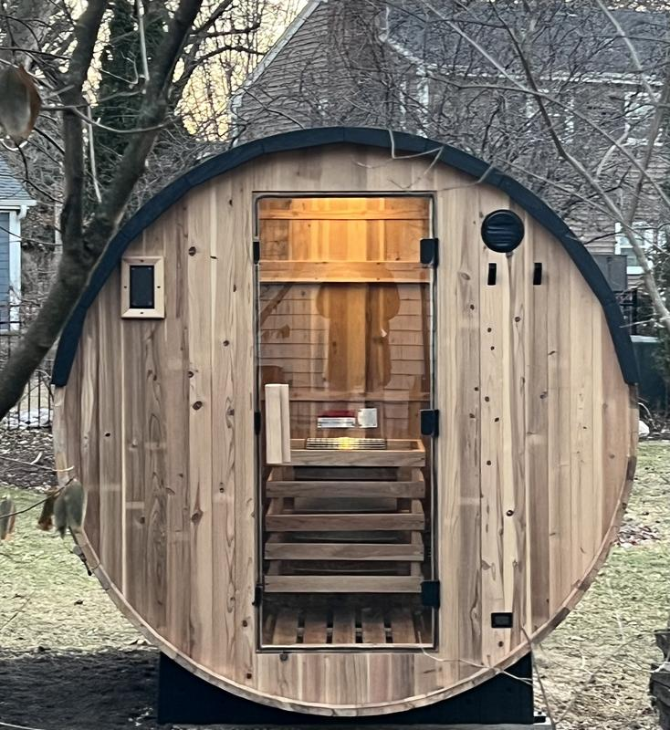 Wooden sauna with a curved exterior in an outdoor setting