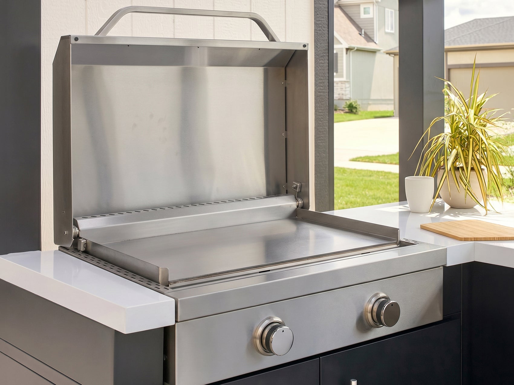 Outdoor griddle made from stainless steel with the lid open built into the Edgemont Bay galvanized steel kitchen.