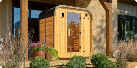 Wooden pod with glass door on a stone building exterior