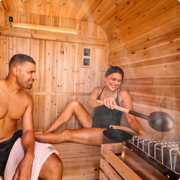 Two people in a wooden sauna with text indicating capacity.