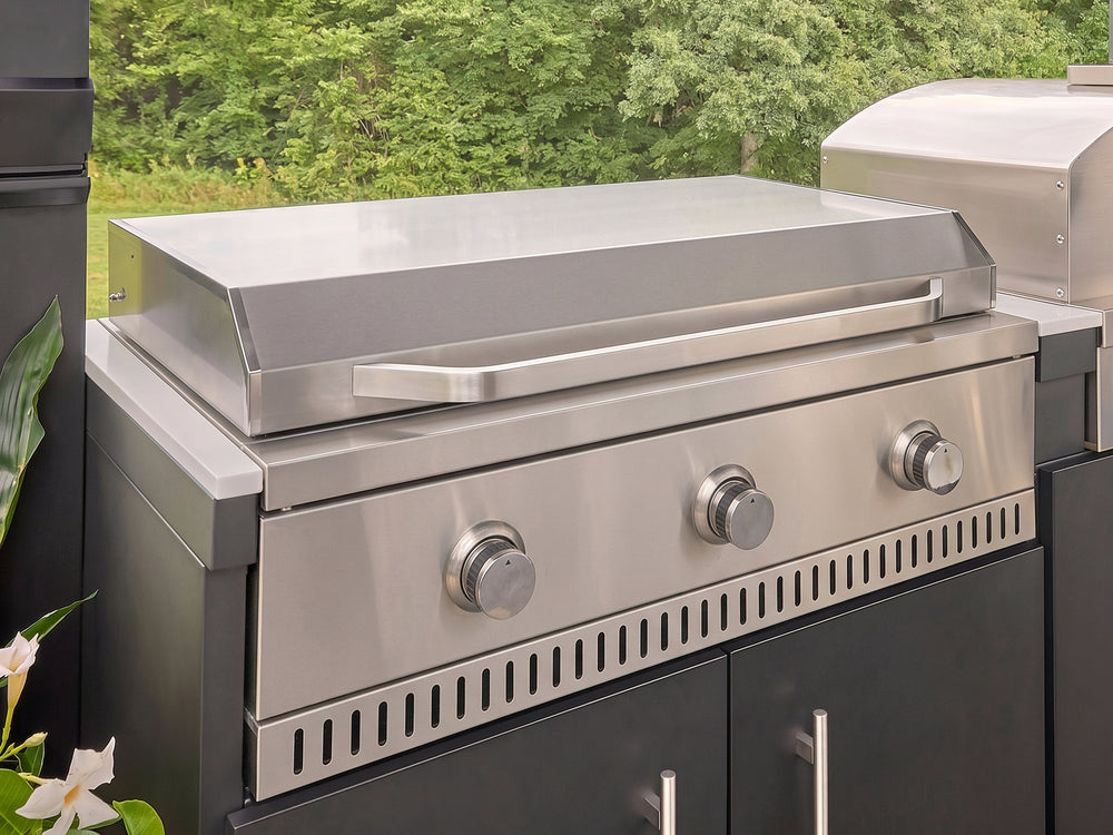 Stainless steel griddle with three control knobs built into the Langston galvanized steel kitchen.