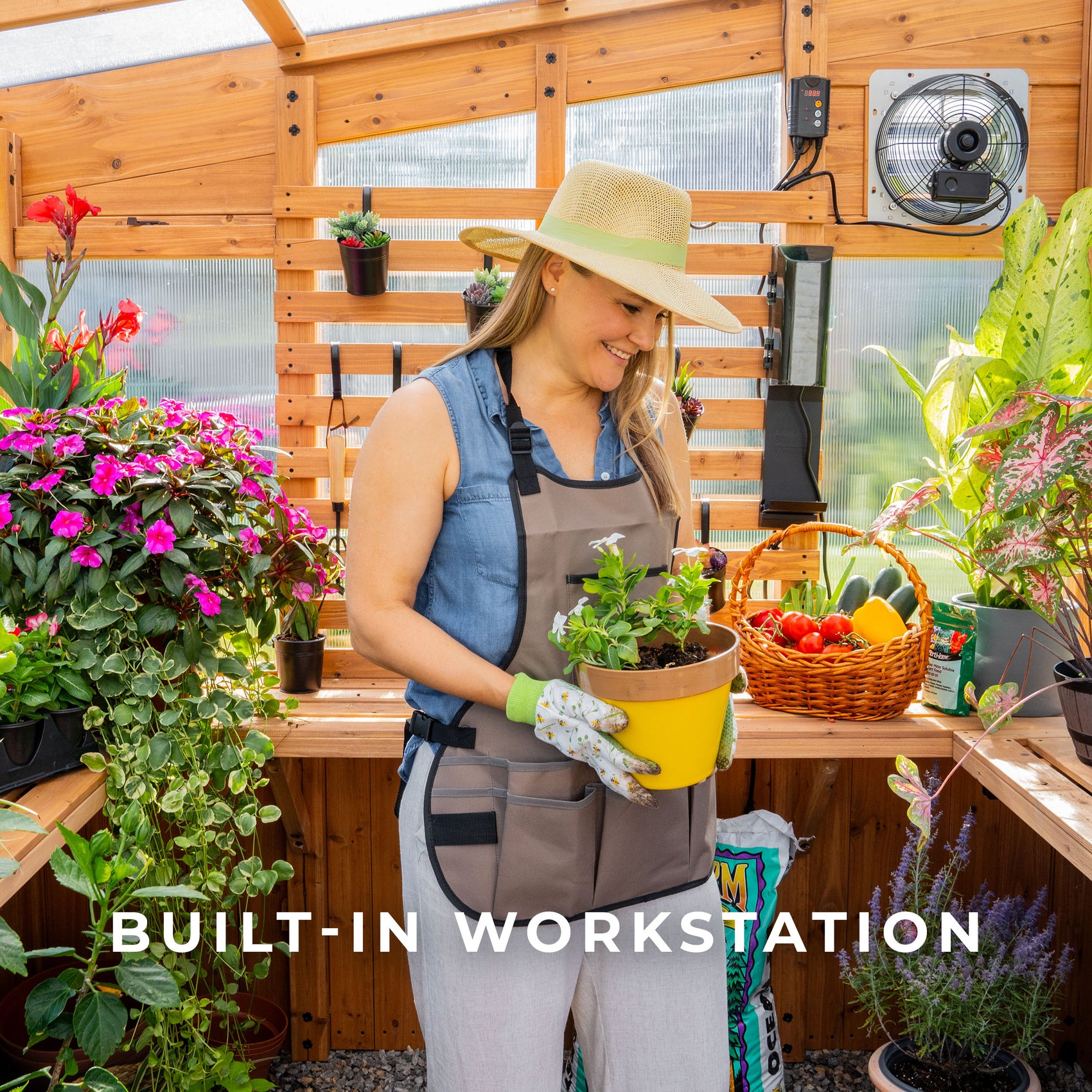 Woman potting plants at the built-in cedar workstation shelf inside the Zalie greenhouse.