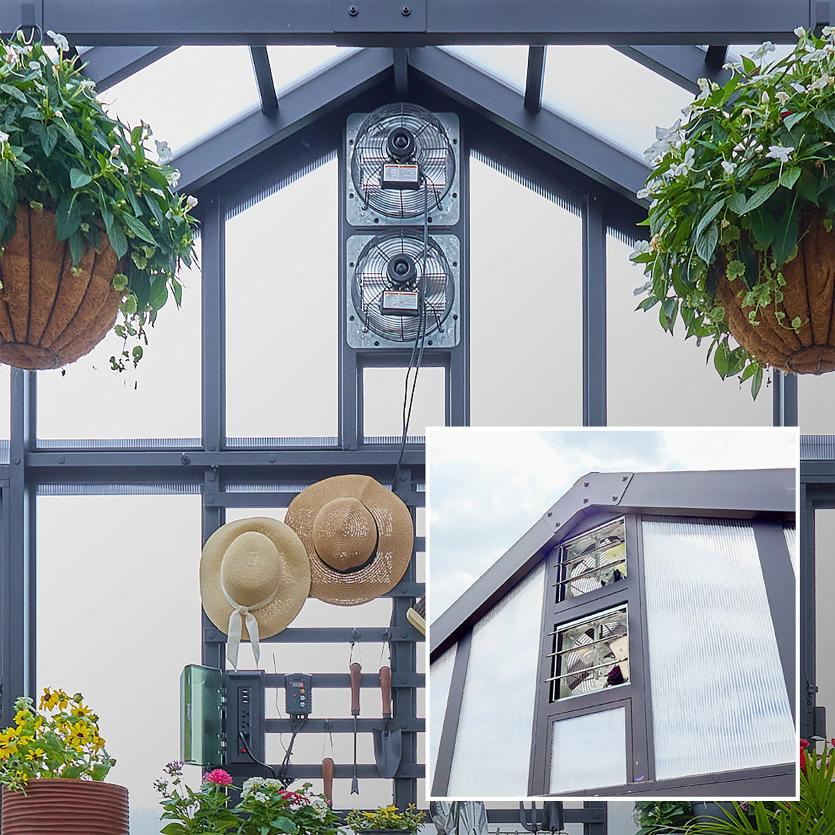 Powder-coated steel greenhouse kit interior showing dual exhaust fans mounted at the gable peak with hanging basket plants.