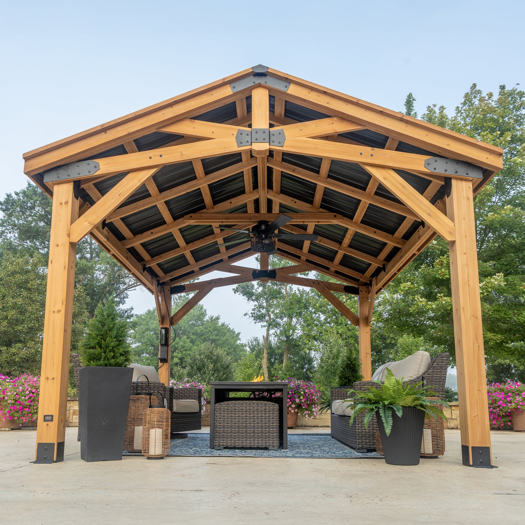 Vaulted ceiling inside cedar gazebos showing exposed beam framework, steel connector plates, and roof panels.