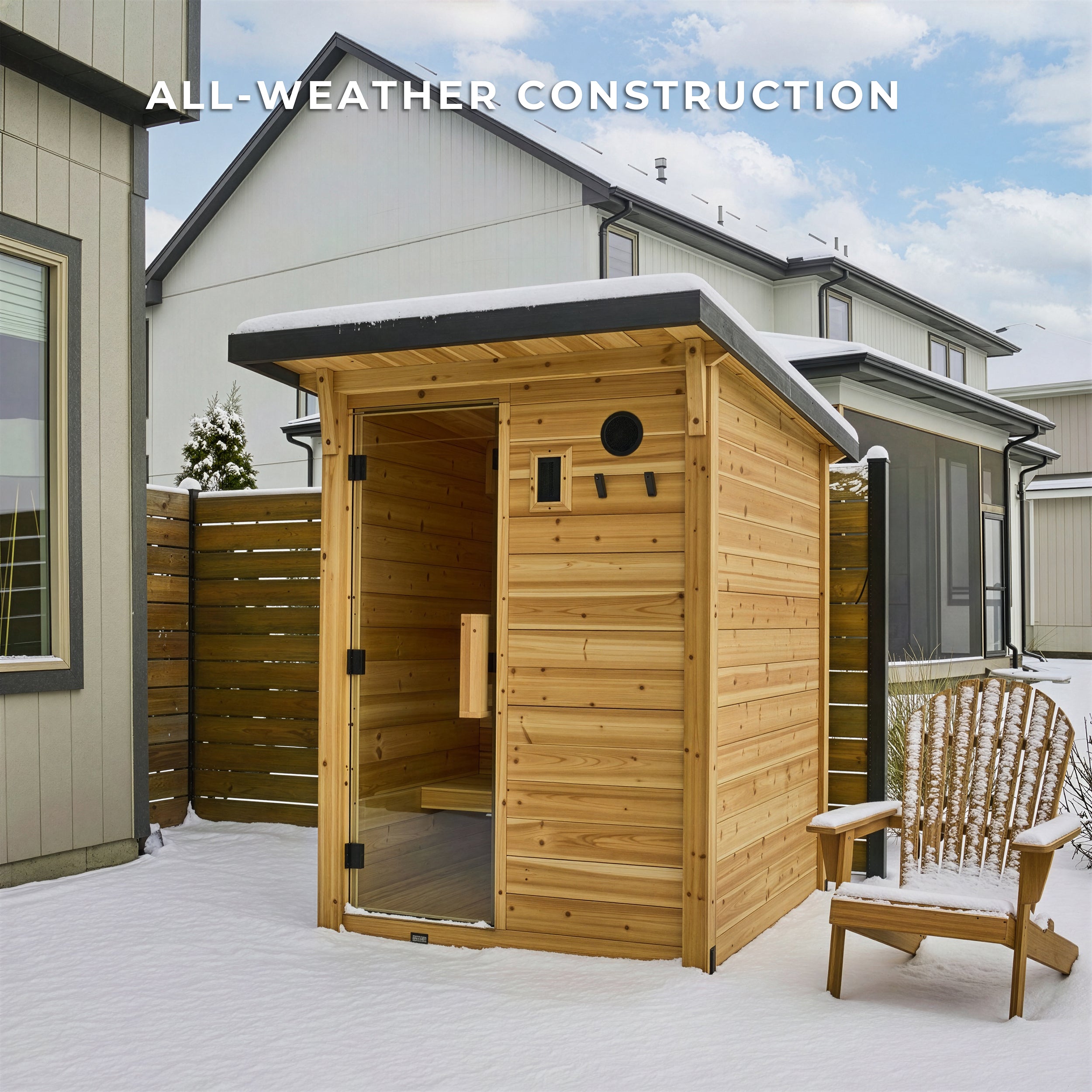 Cedar cabin sauna with open glass door in deep snow showing all-weather wood construction durability