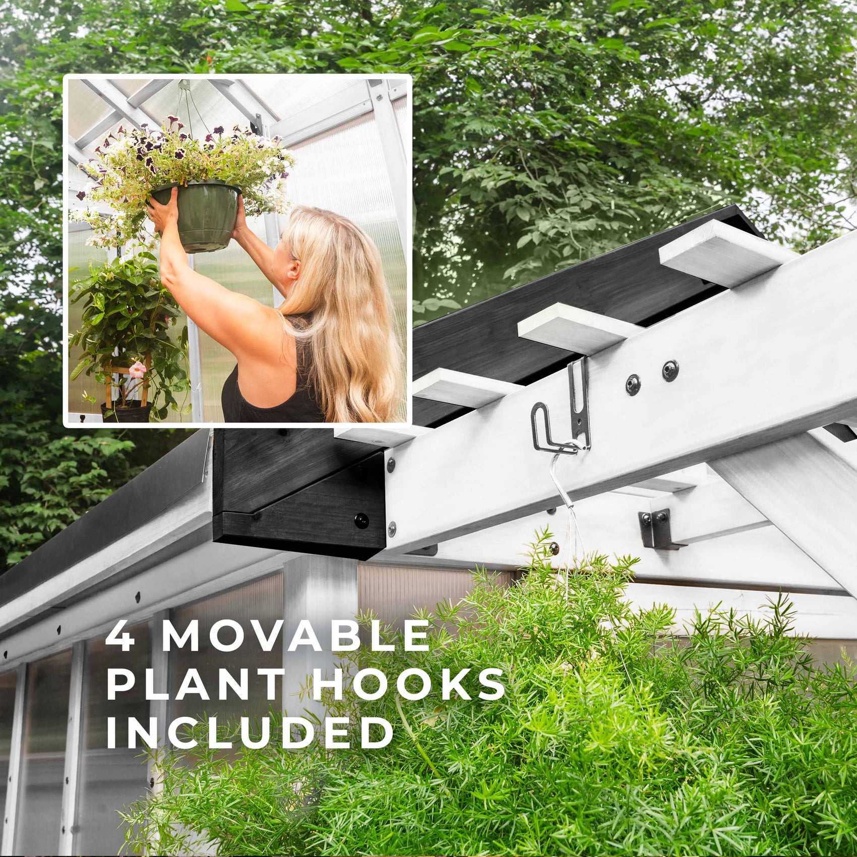 A movable plant hook mounts to the pergola overhang of the White Bellerose greenhouse as a woman hangs a basket inside.