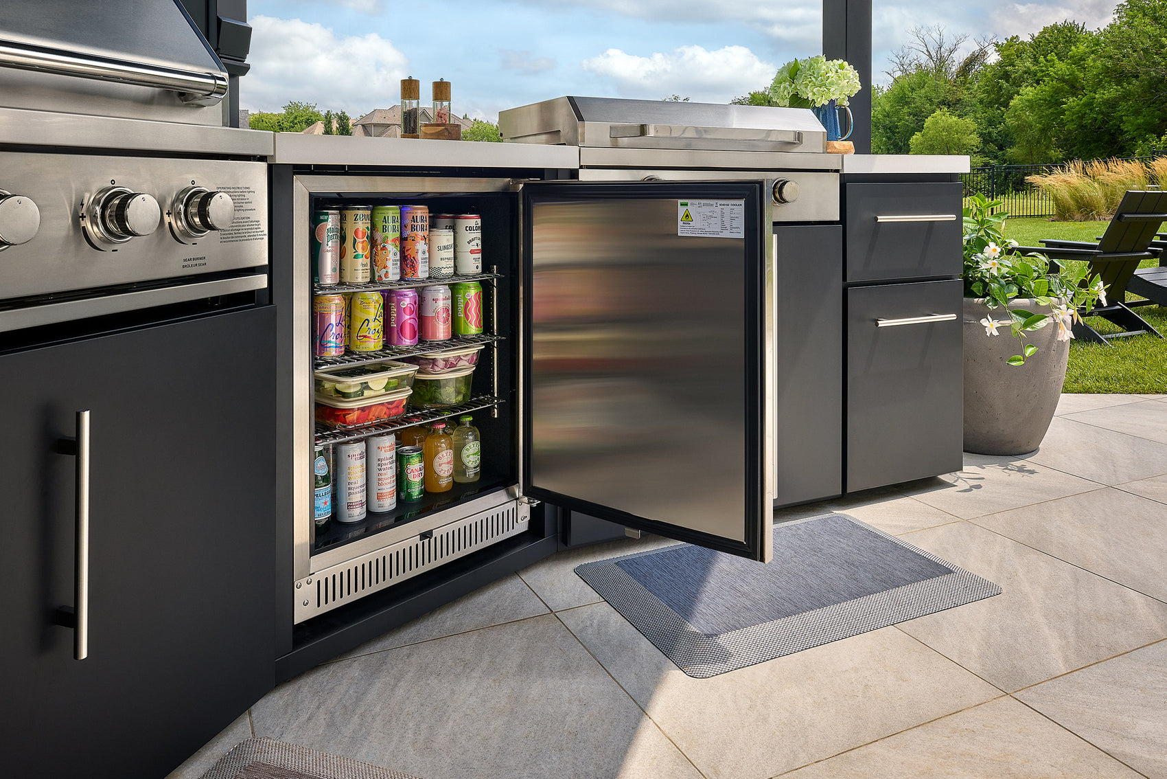 Black protective cover over the pizza oven on the Edgemont Cove Outdoor Kitchen, covering the chimney and body