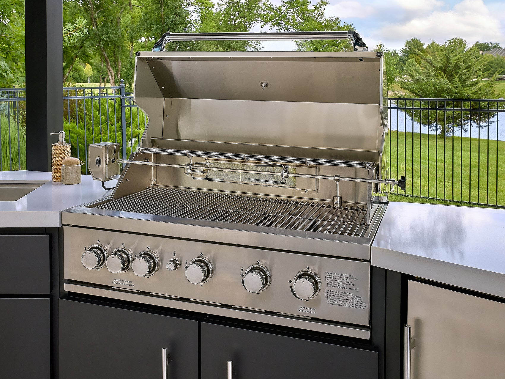 Edgemont Cove Outdoor Kitchen countertop with flush-mounted sink cover closed, showing seamless white engineered stone surface