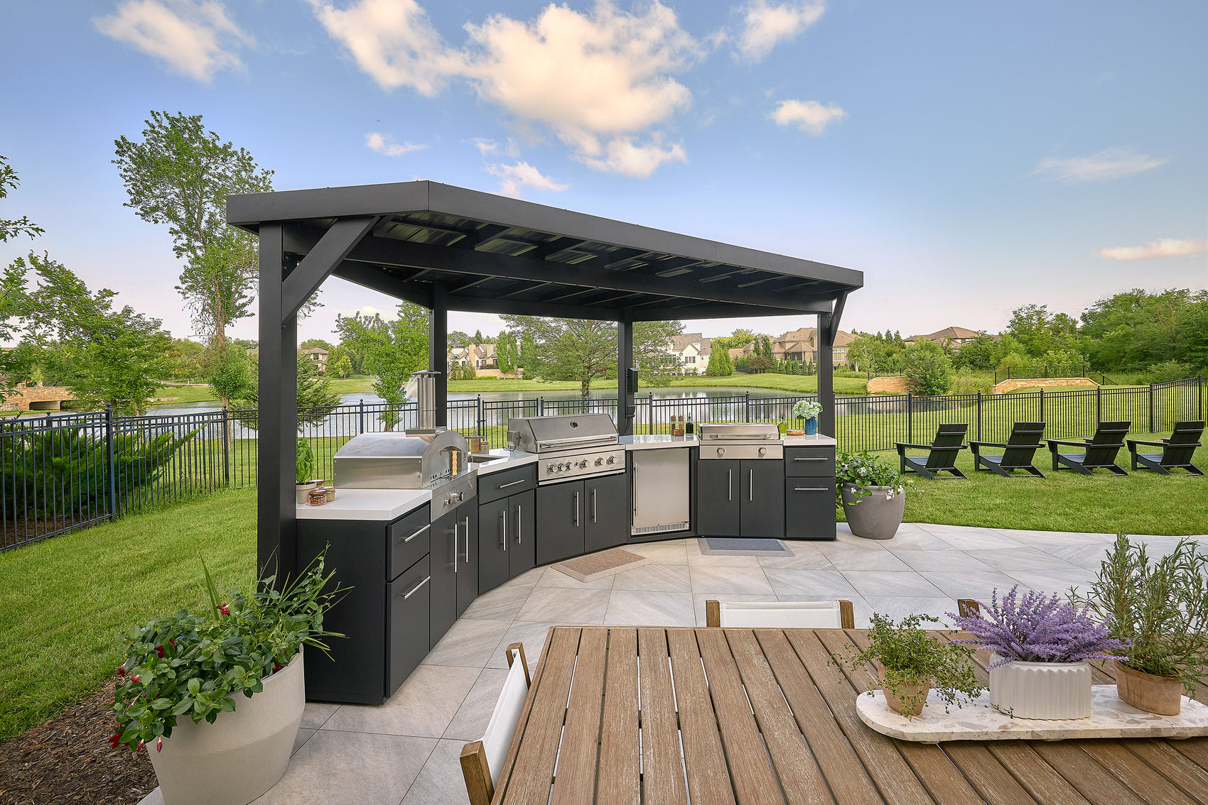 Edgemont Cove Outdoor Kitchen pull-out trash drawer open from above showing liner-lined waste bin, full kitchen layout visible in background