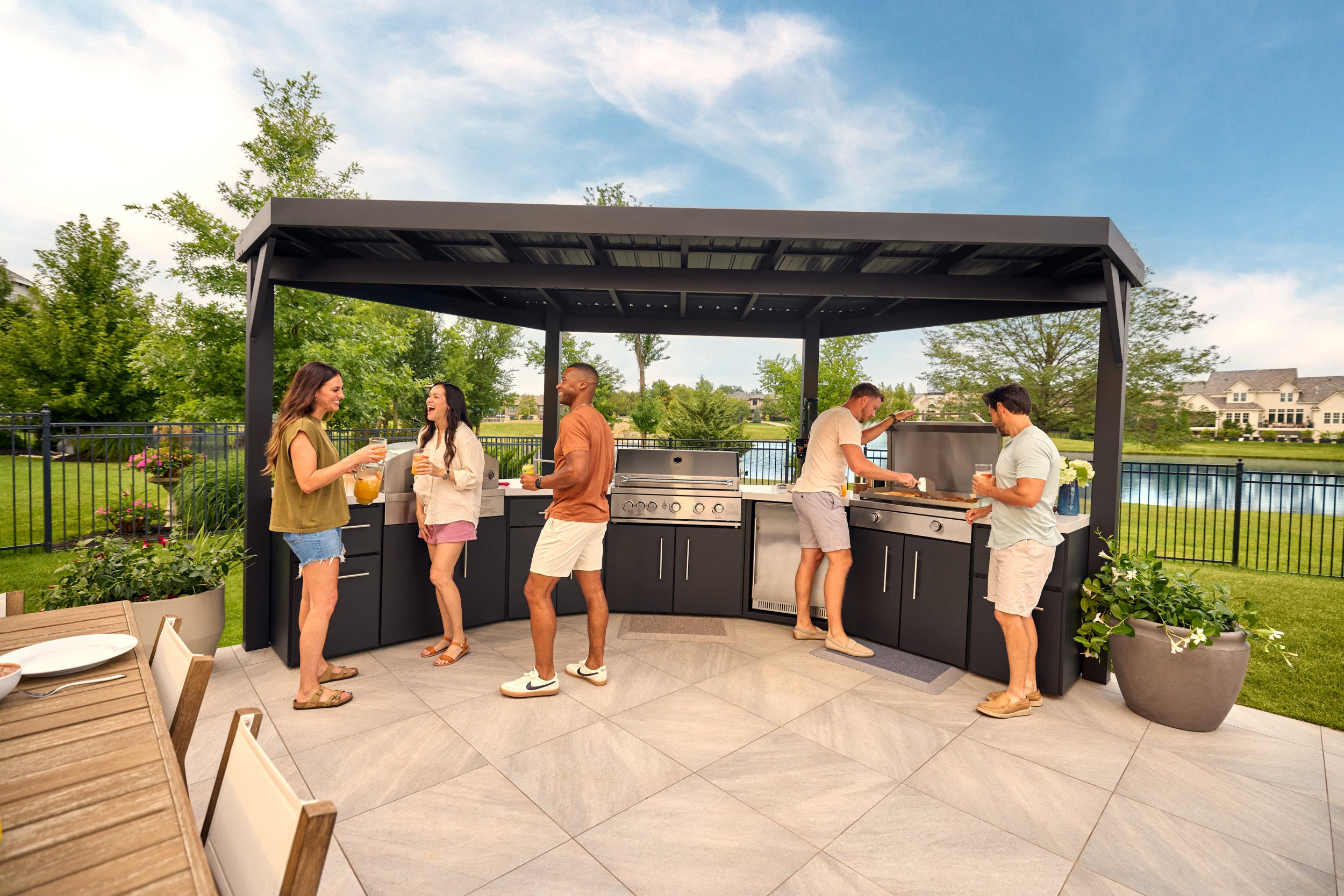 Edgemont Cove Outdoor Kitchen deep storage drawer open showing organized divider tray with utensils, dish towels, and cutlery inside