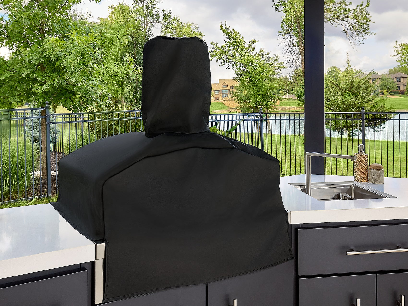 Edgemont Cove Outdoor Kitchen stainless steel flat-top griddle with lid open and clean cooking surface, mounted in dark charcoal cabinet base