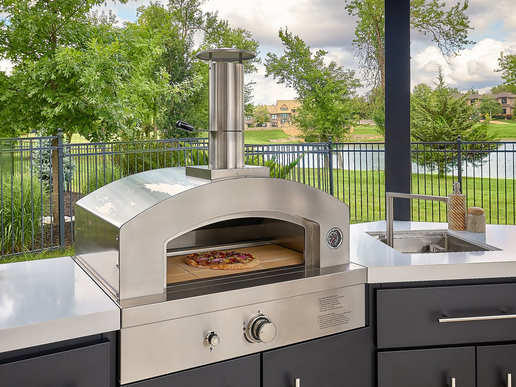 Edgemont Cove Outdoor Kitchen post-mounted weatherproof power port open, showing electrical outlets with no devices connected
