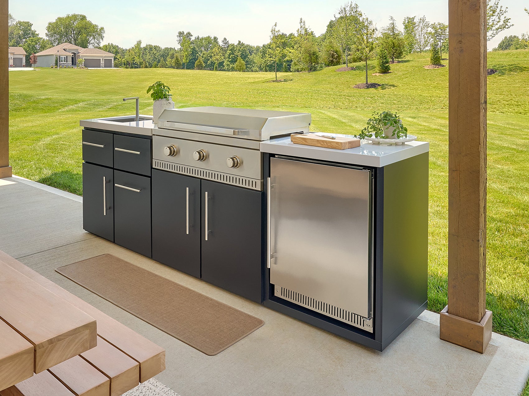 Emory outdoor kitchen featuring a stainless steel griddle, engineered stone countertops, galvanized steel cabinets.