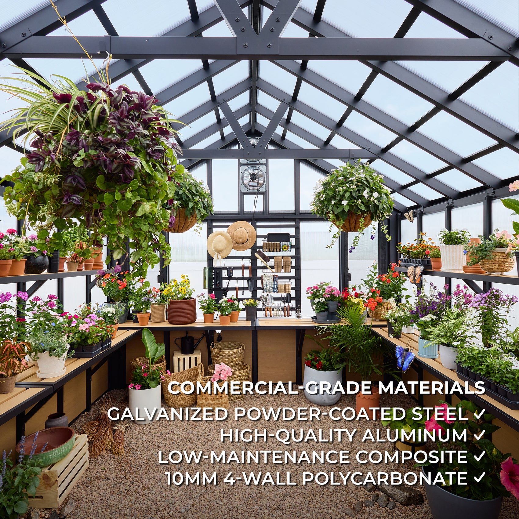 The Larkspur garden greenhouse interior filled with potted flowers, hanging baskets, and staging shelves along both sides.