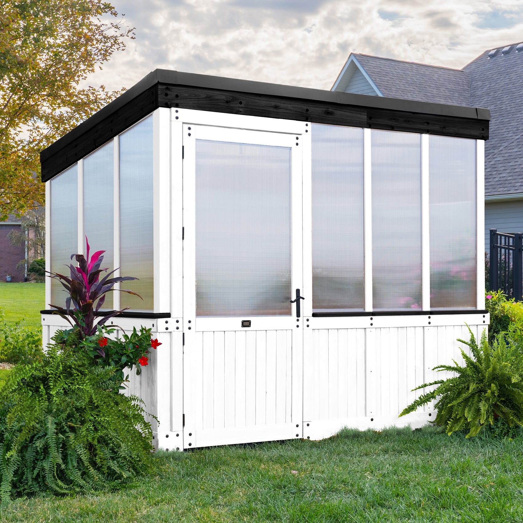 Backyard Discovery White Willow greenhouse with a wide entry door, polycarbonate panels, and a sloped roof.