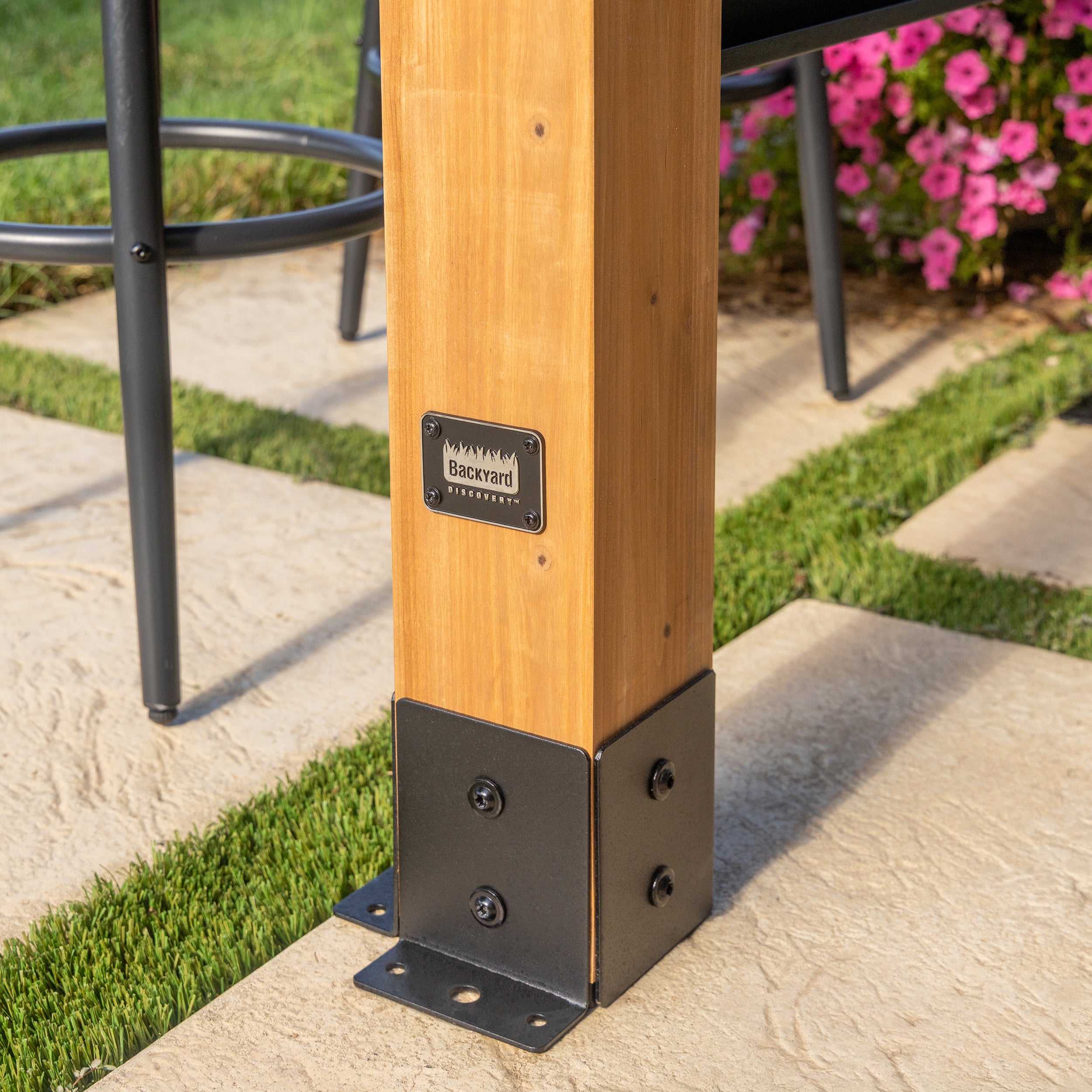 Cedar post base with powder-coated steel anchoring plate on outdoor grill gazebo patio installation.