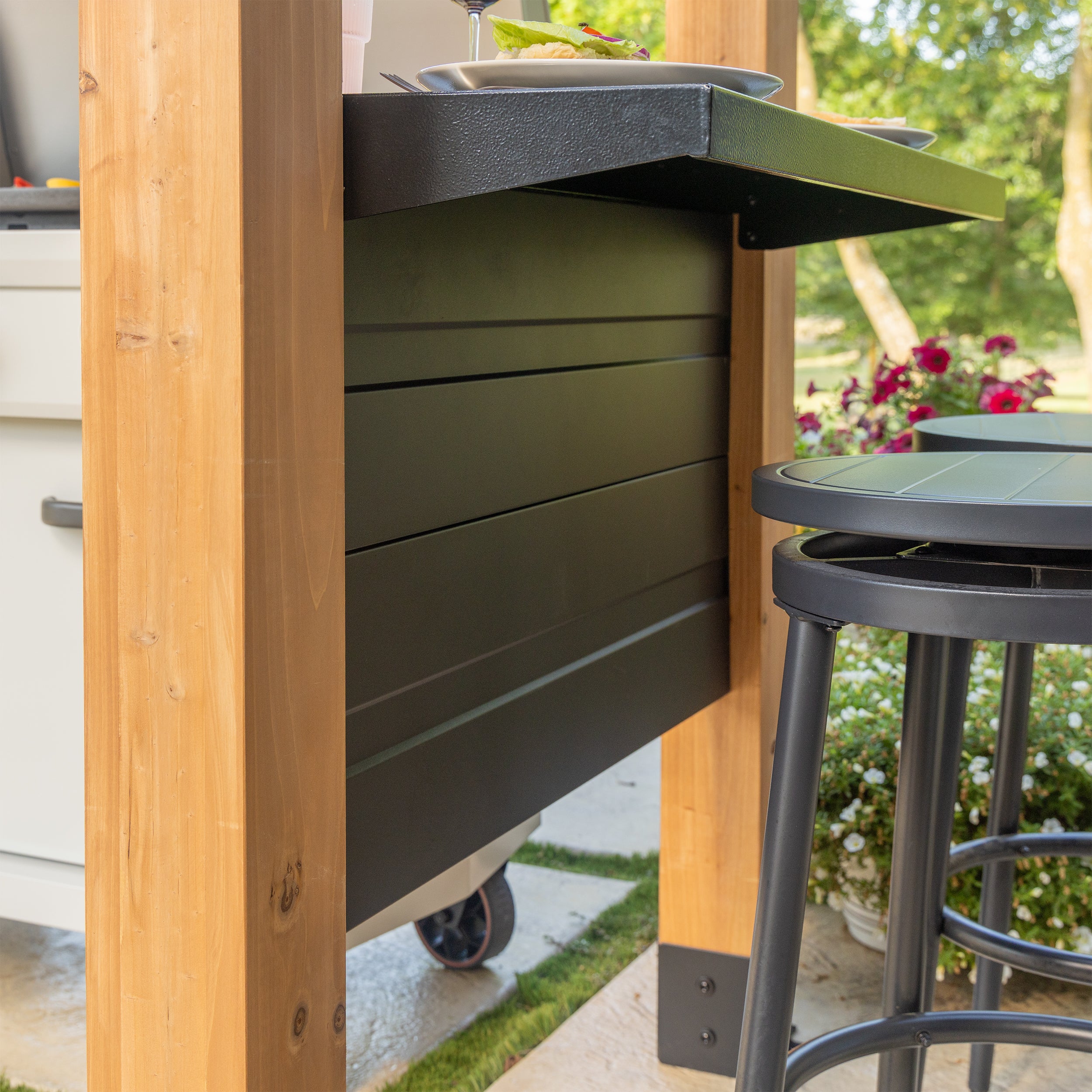 Cedar grilling gazebo with steel panel side wall, bar countertop, and modern stools on outdoor patio.