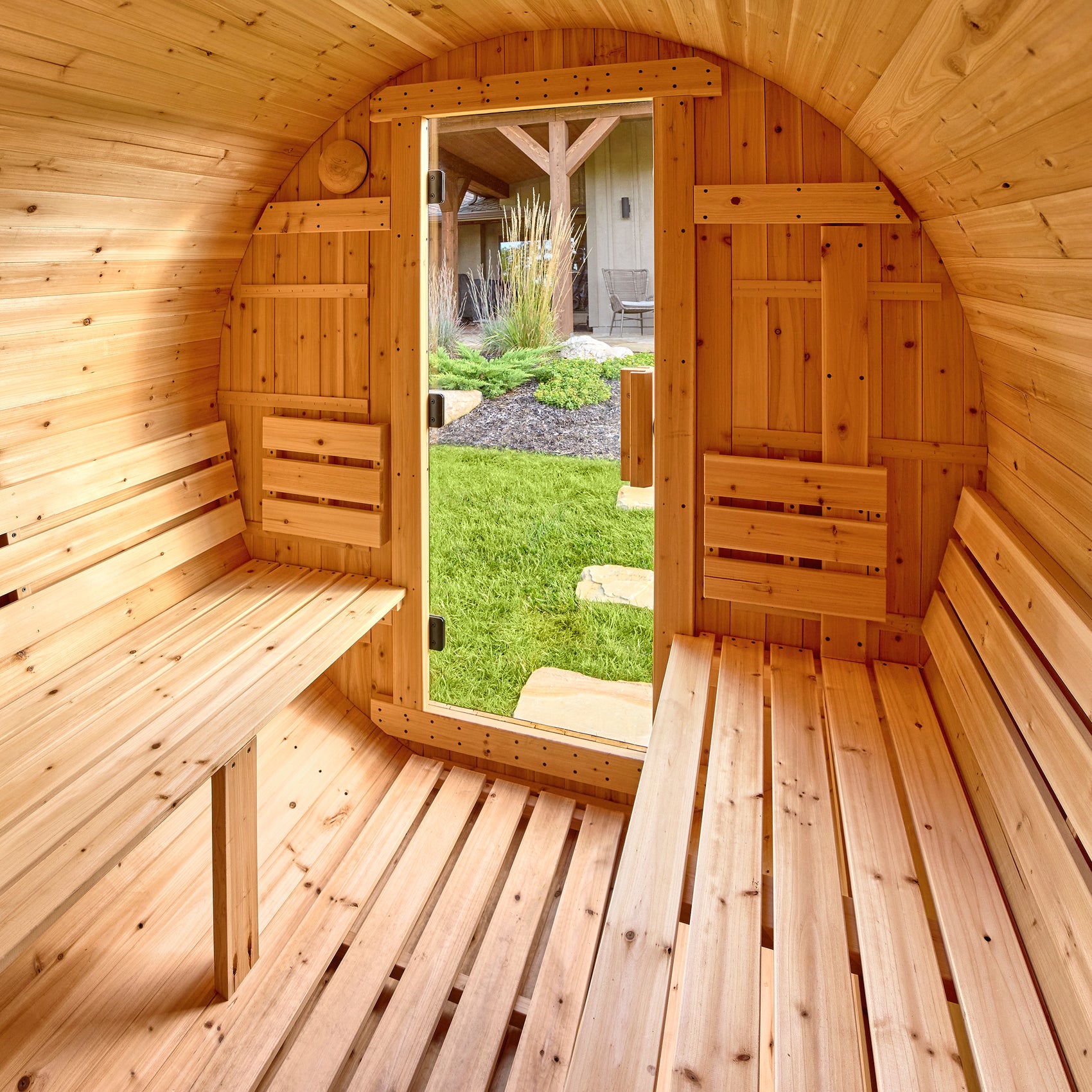 Interior of the Paxton 4-6 person outdoor barrel cedar sauna with two benches for dry sauna sessions