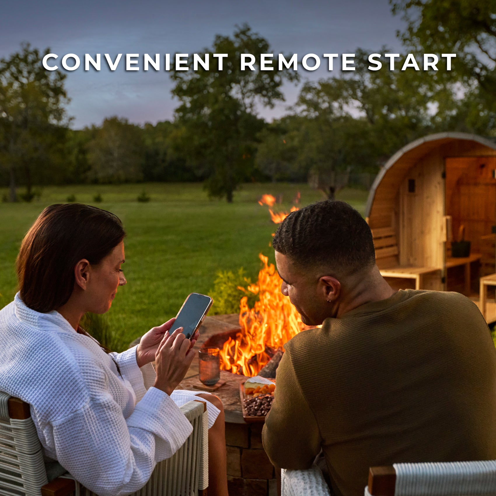 Couple relaxing outside home sauna with porch using convenient remote preheat feature
