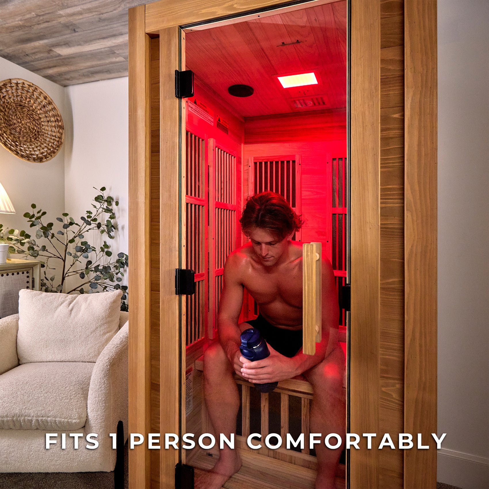 Man using red light therapy sauna session in Rylan 1-person personal indoor infrared sauna with cedar interior