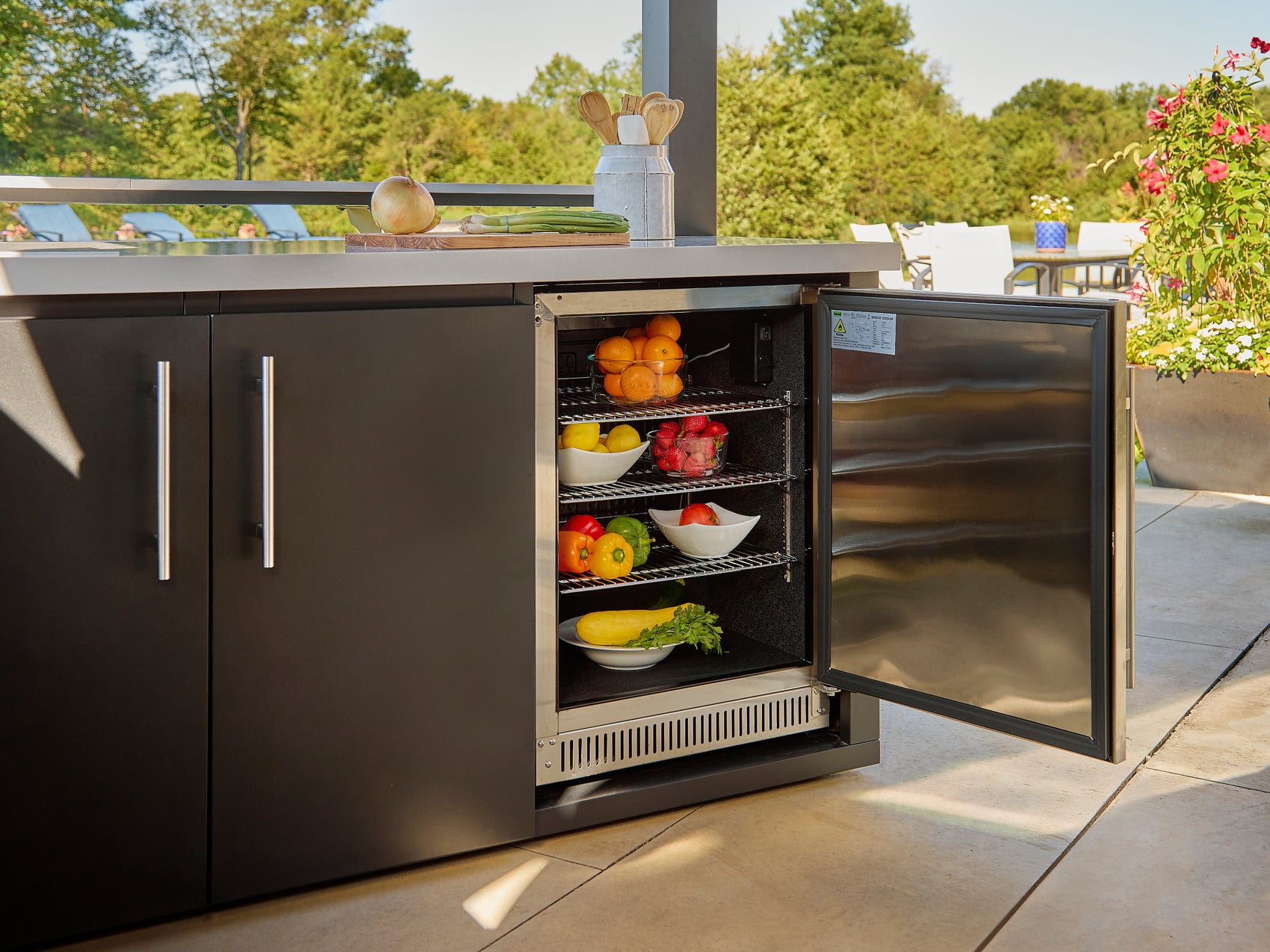 Range Outdoor Living outdoor rated fridge open, with food inside, showing 180 can capacity.