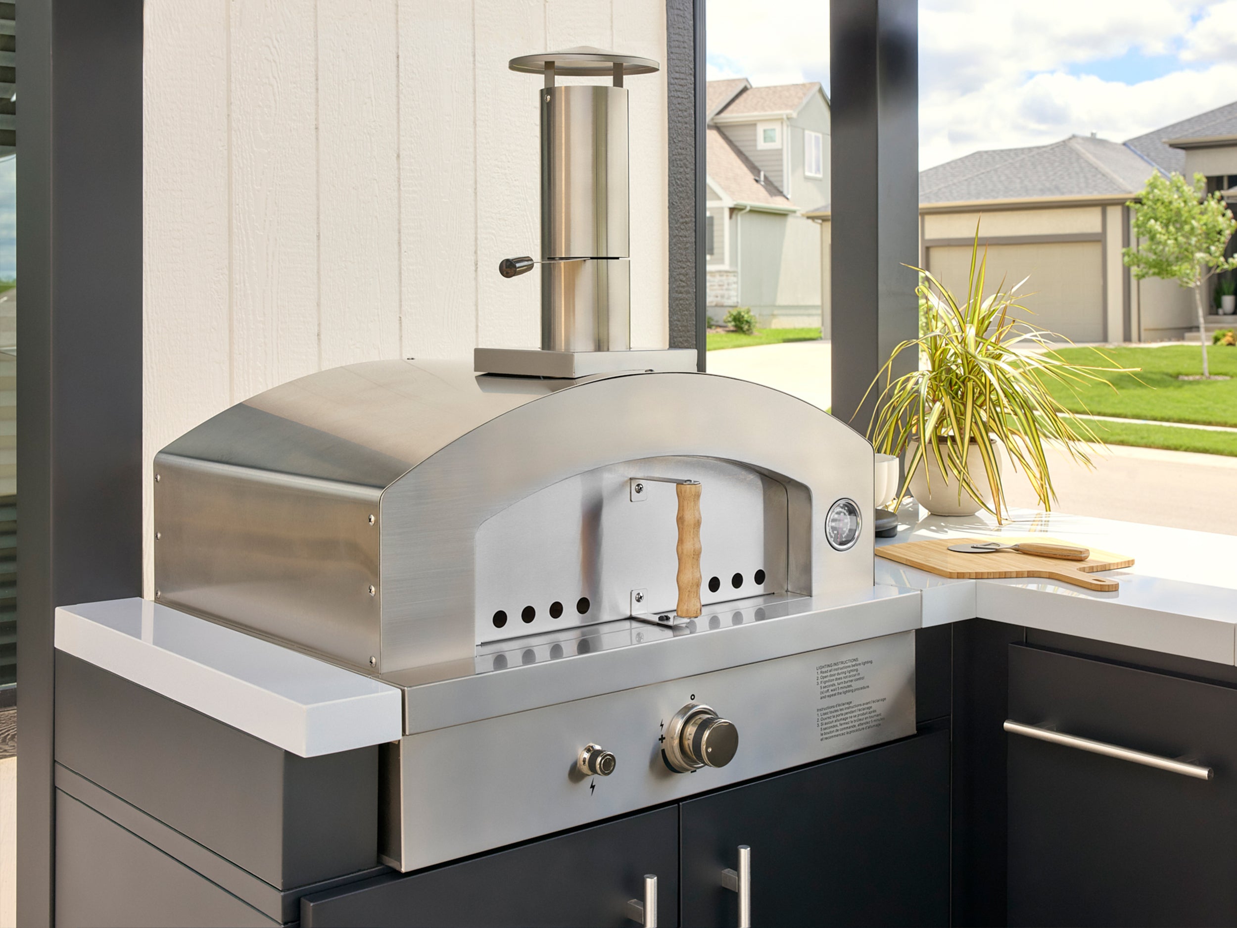 Range Outdoor Living stainless steel artisan pizza oven built into Edgemont Bay outdoor kitchen.