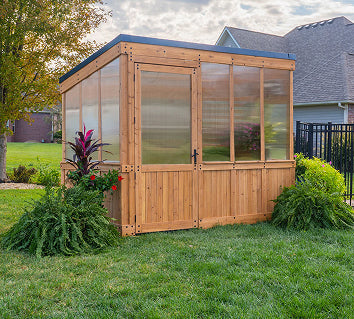 Backyard Discovery cedar wooden greenhouse with 4-wall polycarbonate panels in a backyard setting.