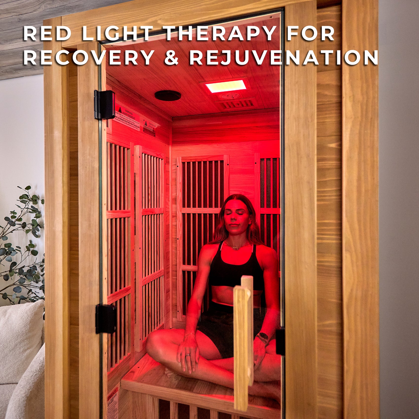 Woman using red light therapy sauna session in Rylan 1-person personal indoor infrared sauna with cedar interior