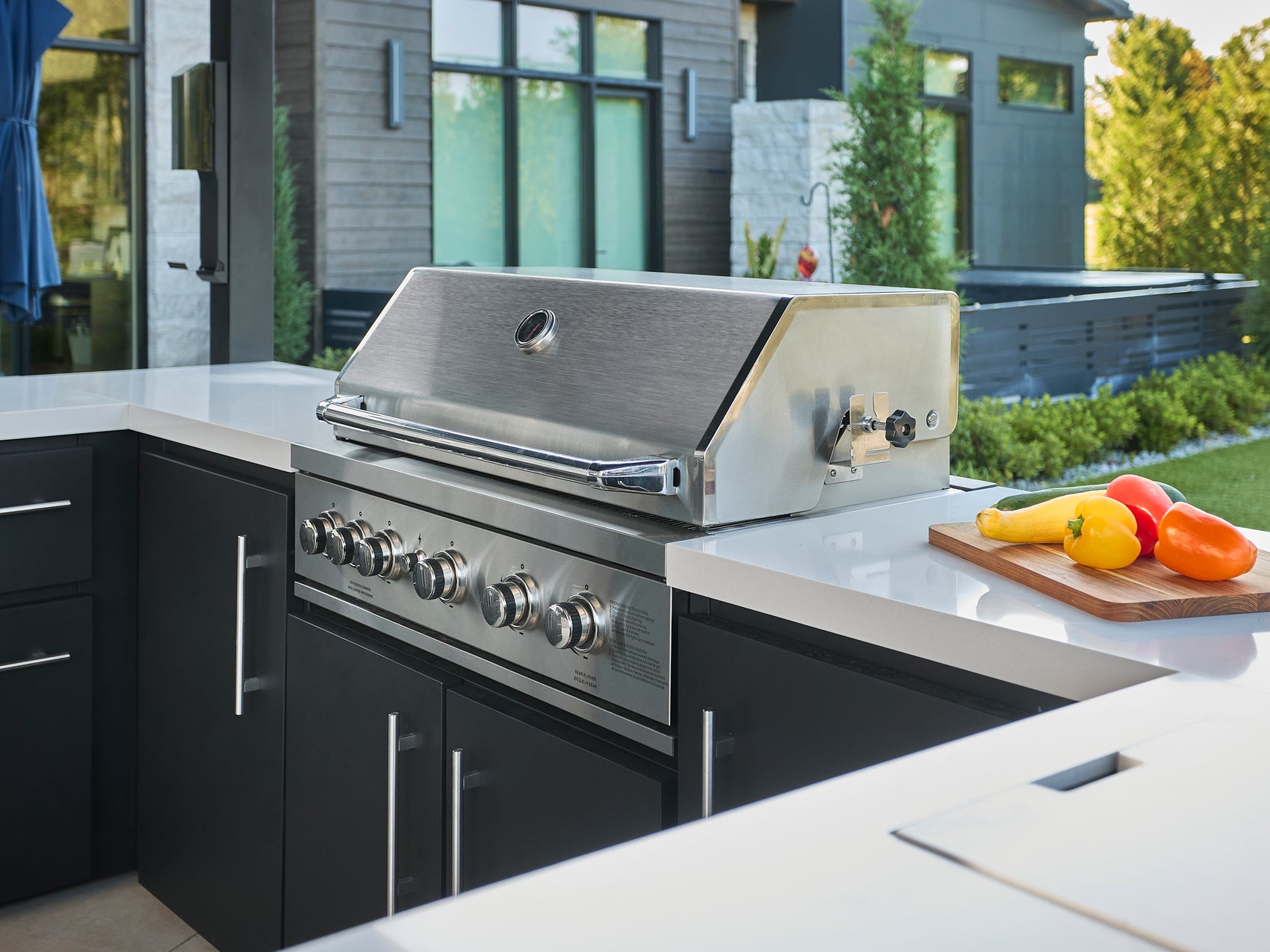5-burner outdoor grill with stainless steel lid built into Edgemont Bay outdoor kitchen.