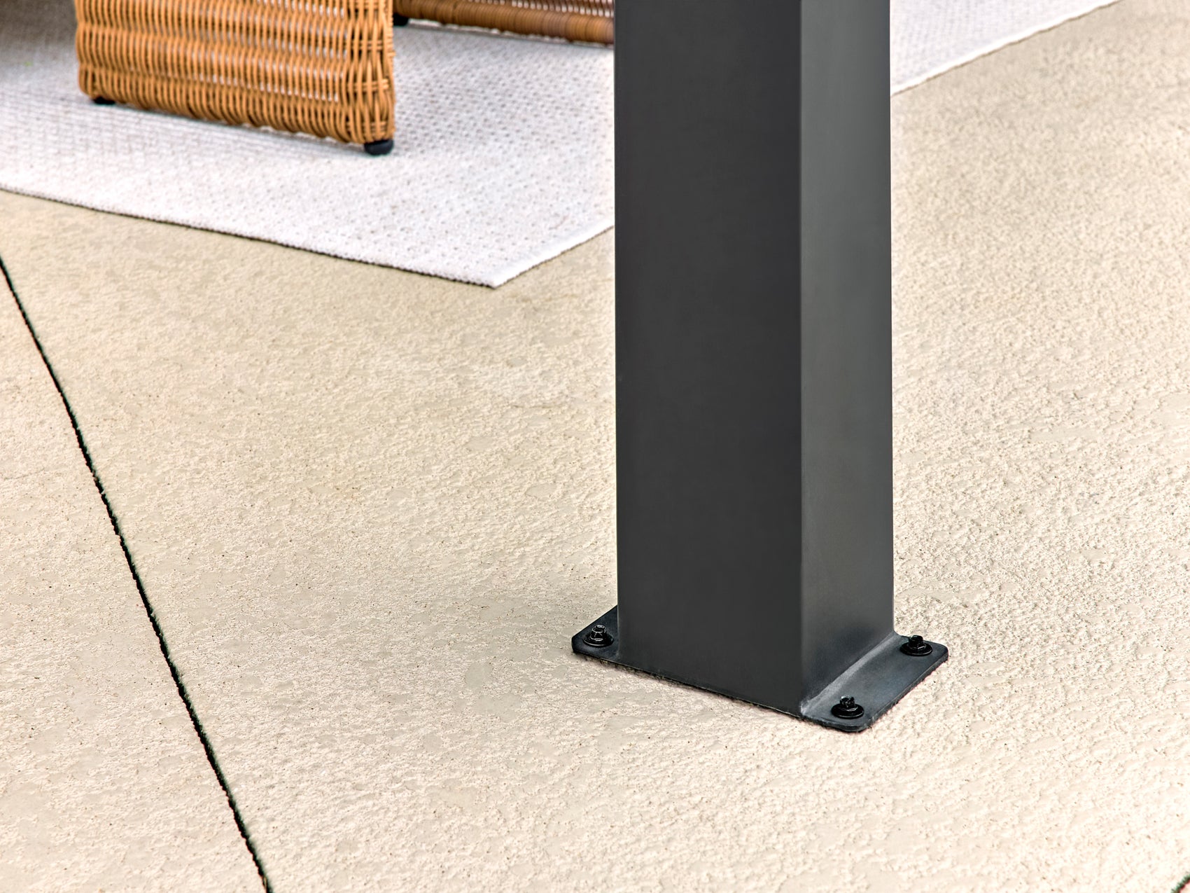 Range Outdoor Living Lancaster steel gazebo post base plate with mounting screws secured to patio surface.
