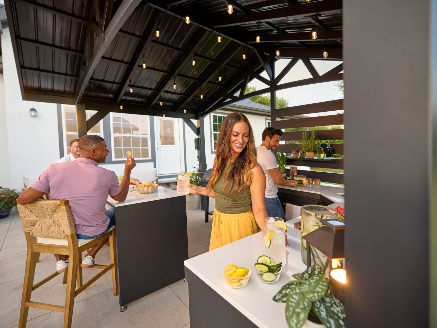 Range Outdoor Living Langston backyard kitchen where friends gather for drinks on sunny patio.